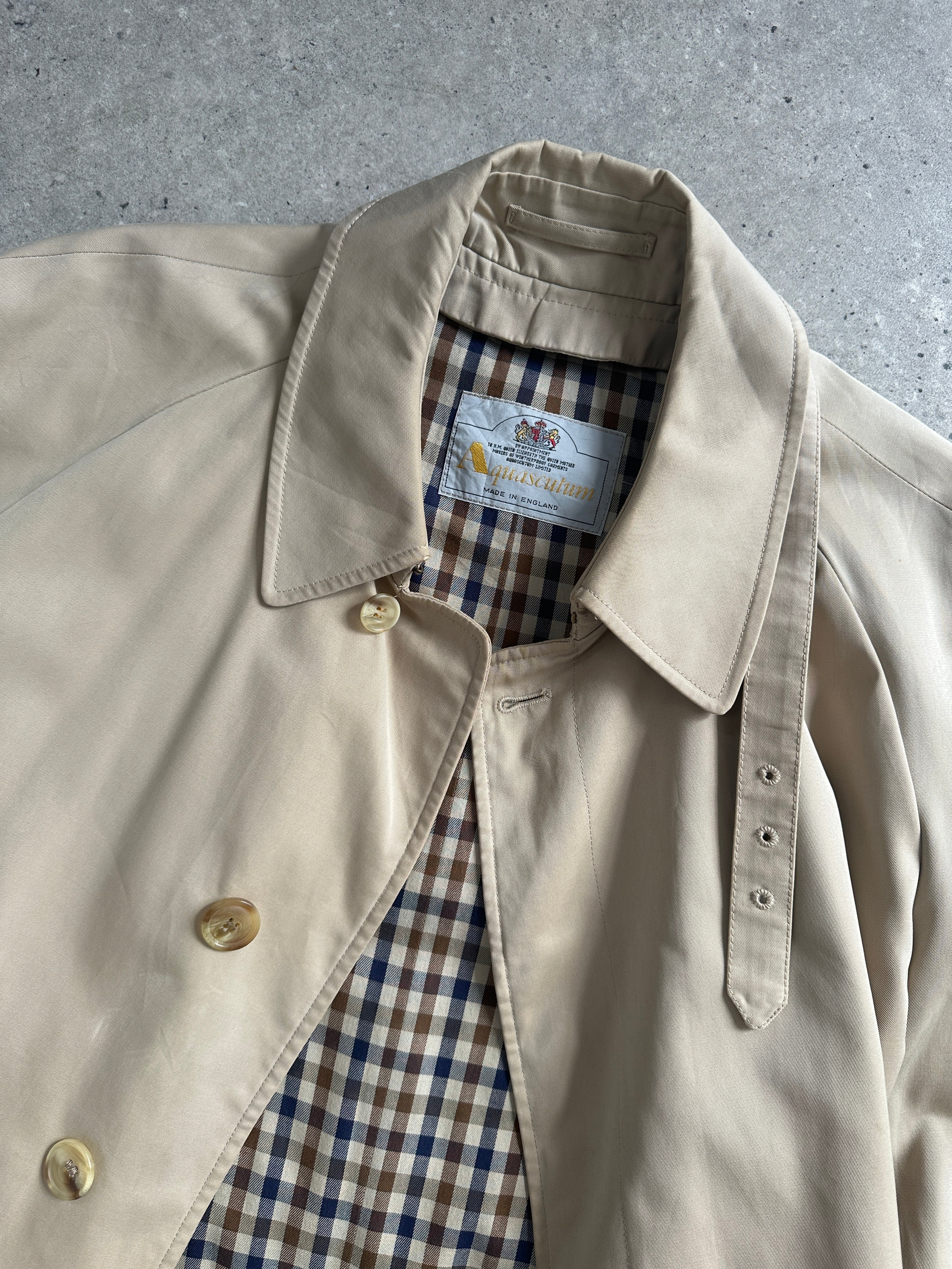 Aquascutum pure cotton trench coat with concealed placket and belt, in a classic design, shown in a size L.