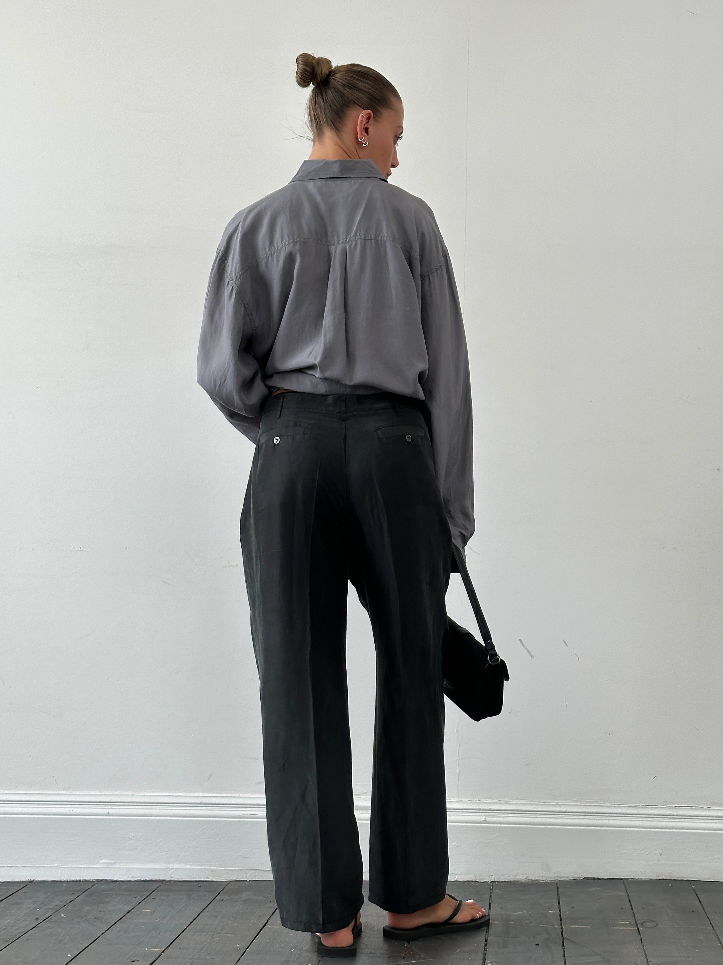 Vintage pure silk high-waisted straight-leg trousers in W32, showcasing their elegant fit and smooth fabric.