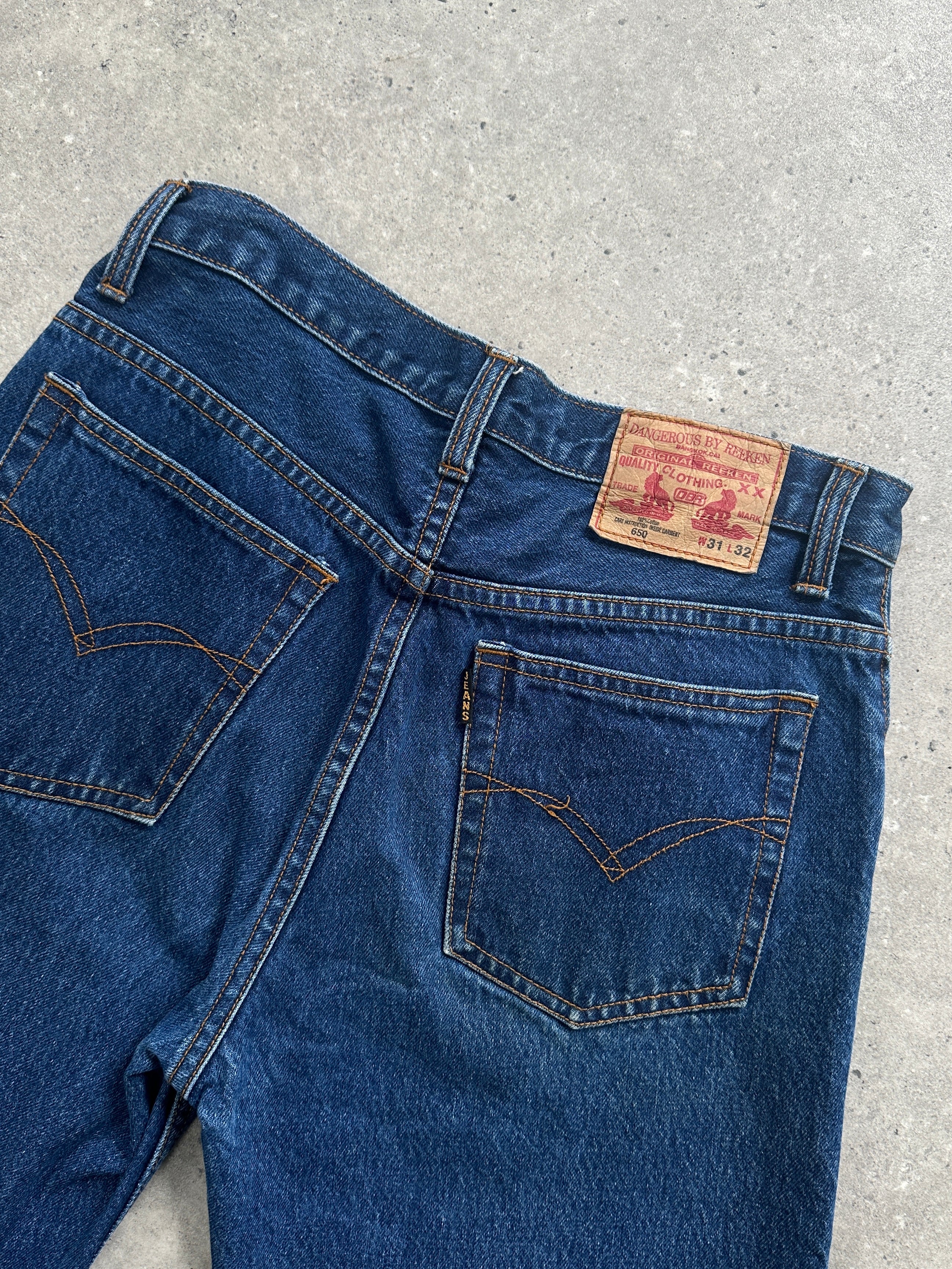 Vintage pure cotton straight-leg denim jeans in size W28, showing classic blue fabric and traditional stitching.