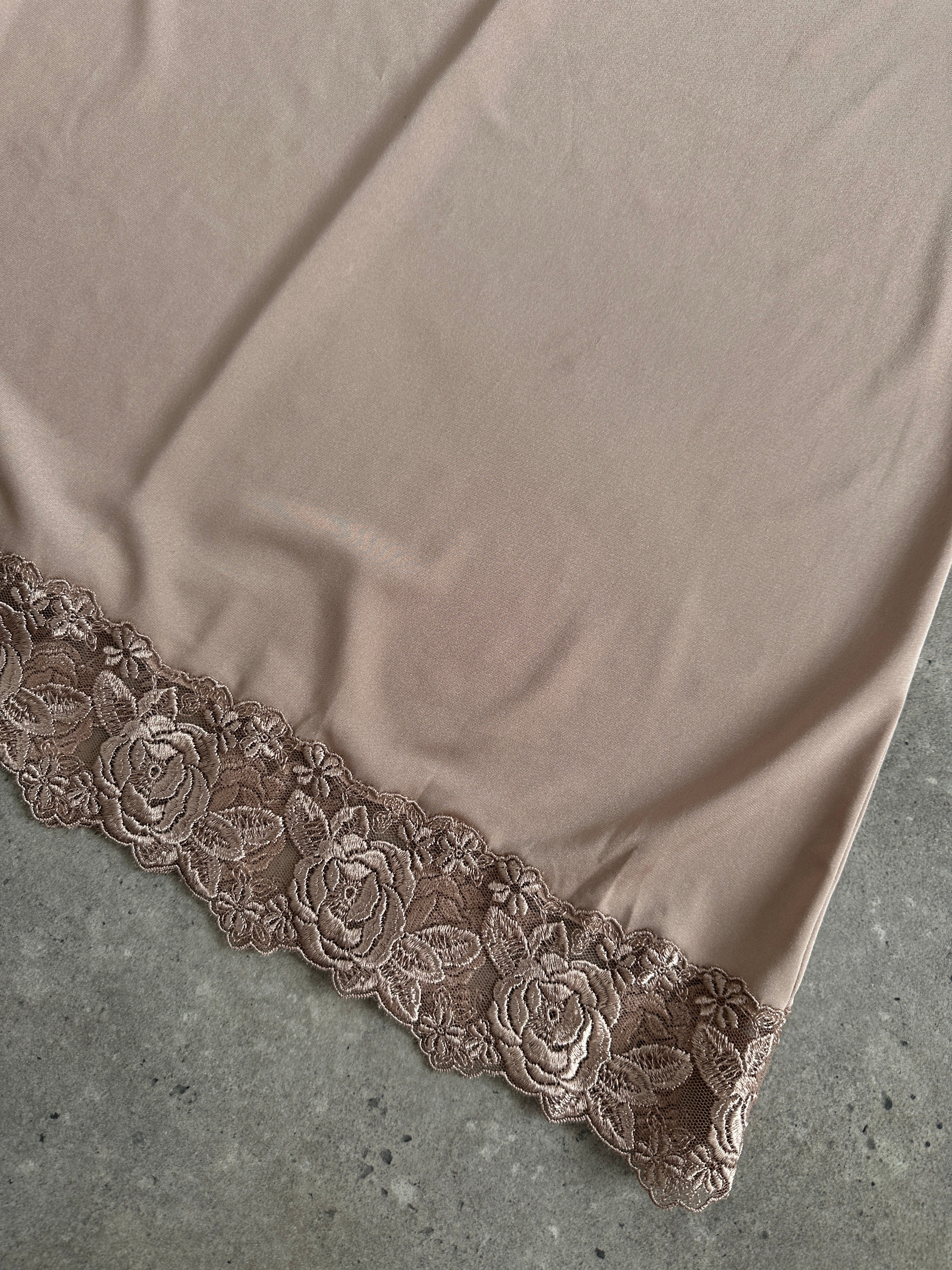 Vintage 1990s lace mini slip dress in size M, featuring delicate lace fabric and a fitted silhouette.
