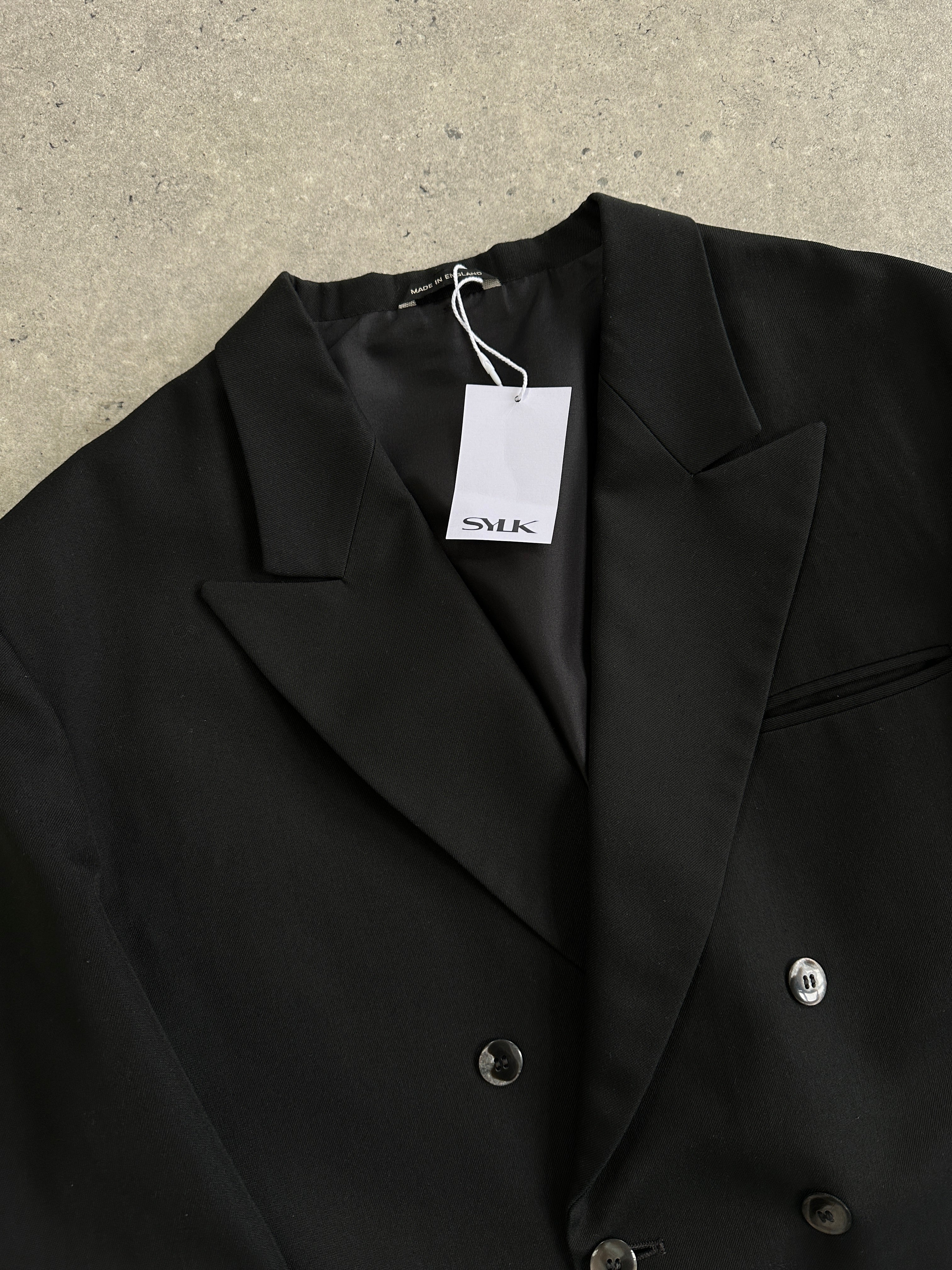 Vintage 1980s cropped double-breasted blazer in classic design, featuring structured shoulders and a tailored fit.