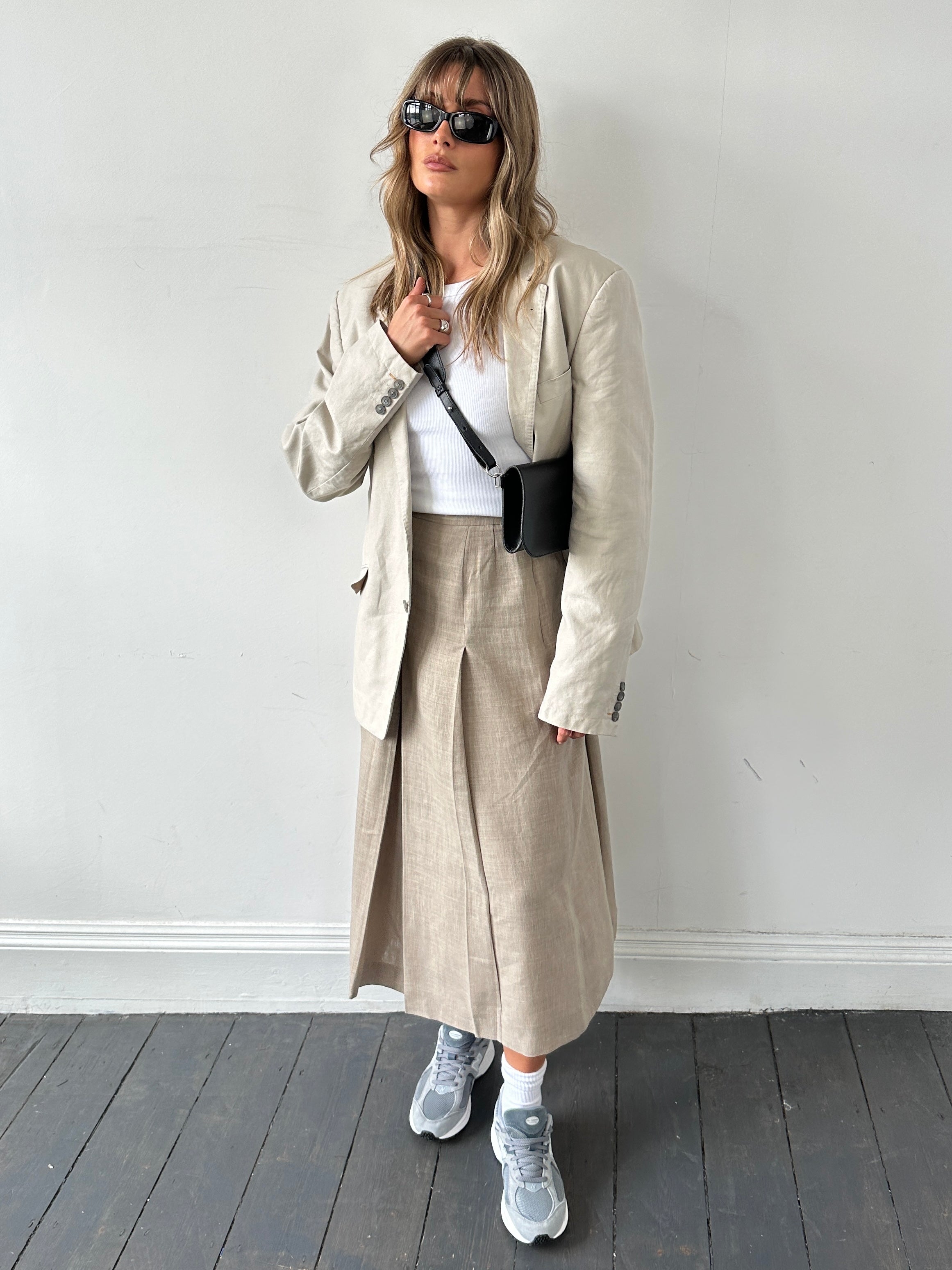 Jaeger pleated linen midaxi skirt in natural beige with a high waist and flowing design, displayed on a neutral background.