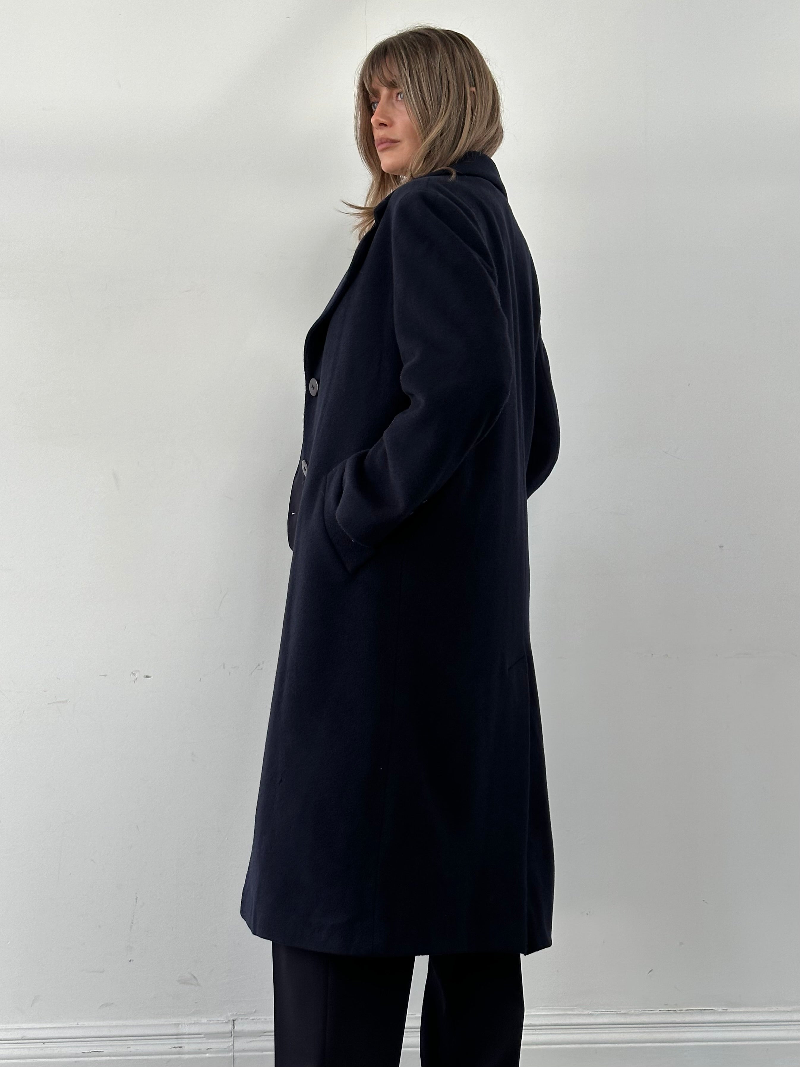 Vintage Virgin Wool Single Breasted Coat in size M, tailored with classic lapels and button closure, displayed on a hanger.
