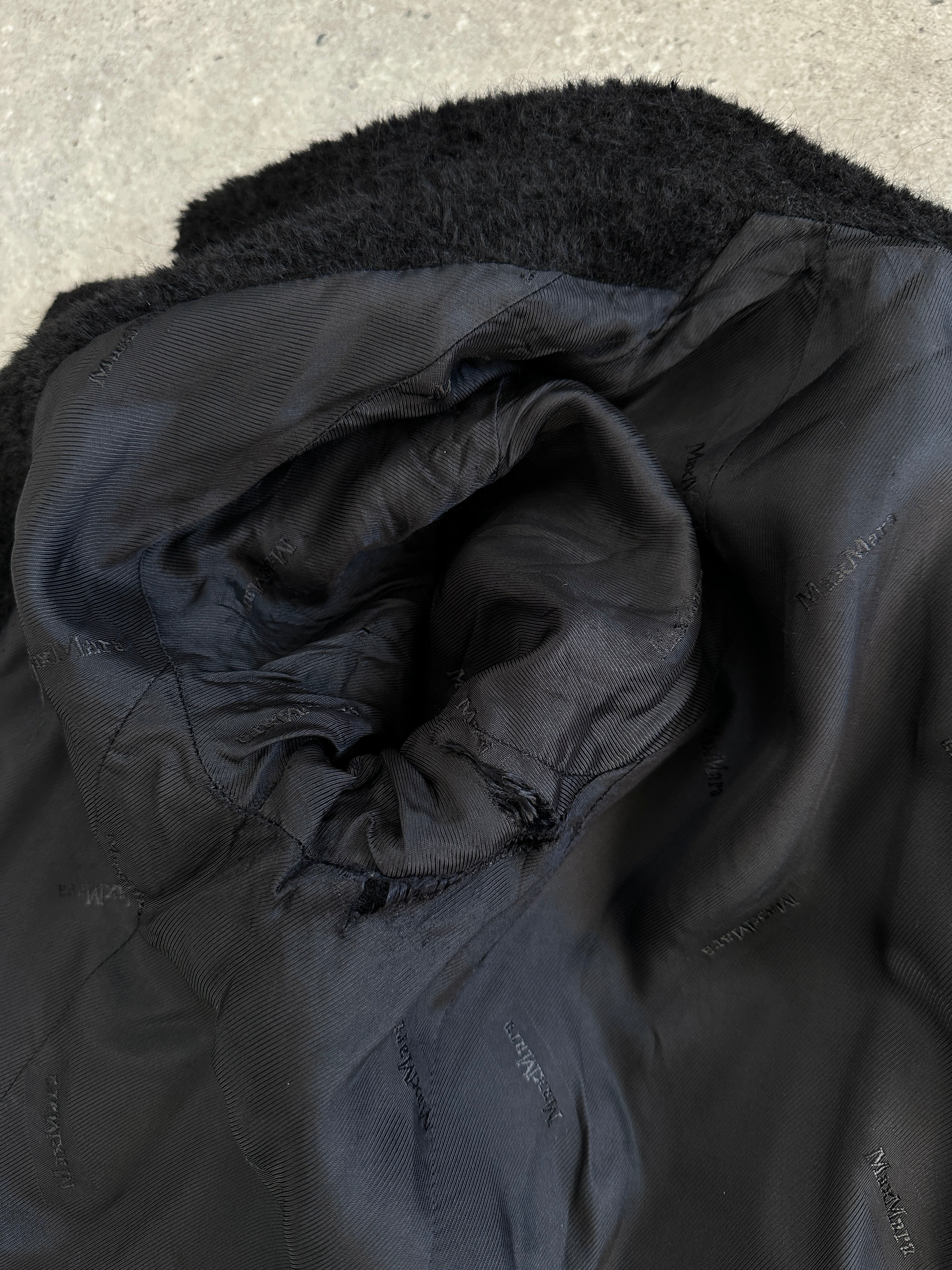 Max Mara Teddy alpaca wool coat in S/M hanging on a wooden hanger, showcasing its plush texture and classic design.