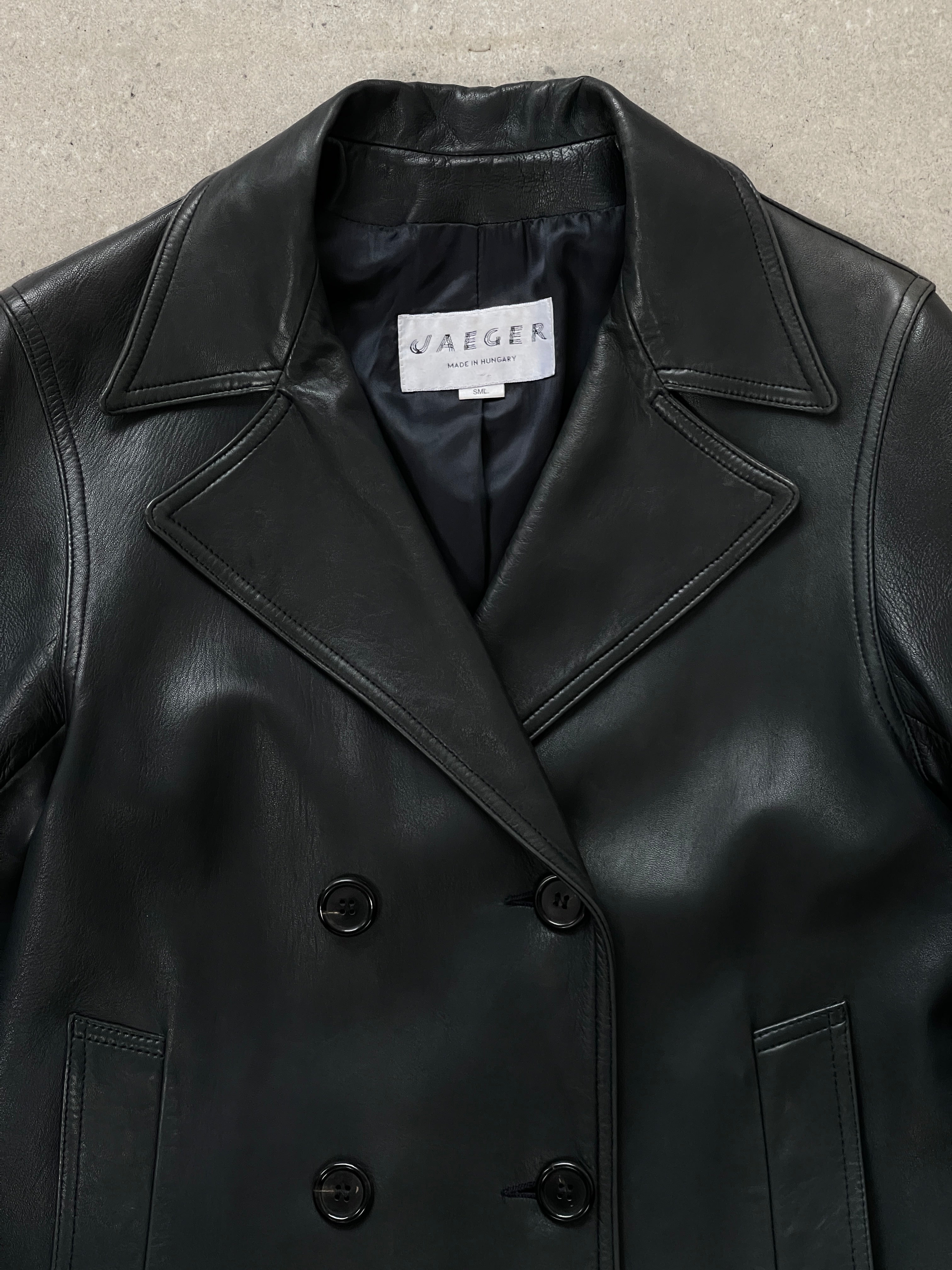 Jaeger 2000s double-breasted leather jacket in black, featuring classic design, lapel collar, and silver button accents.