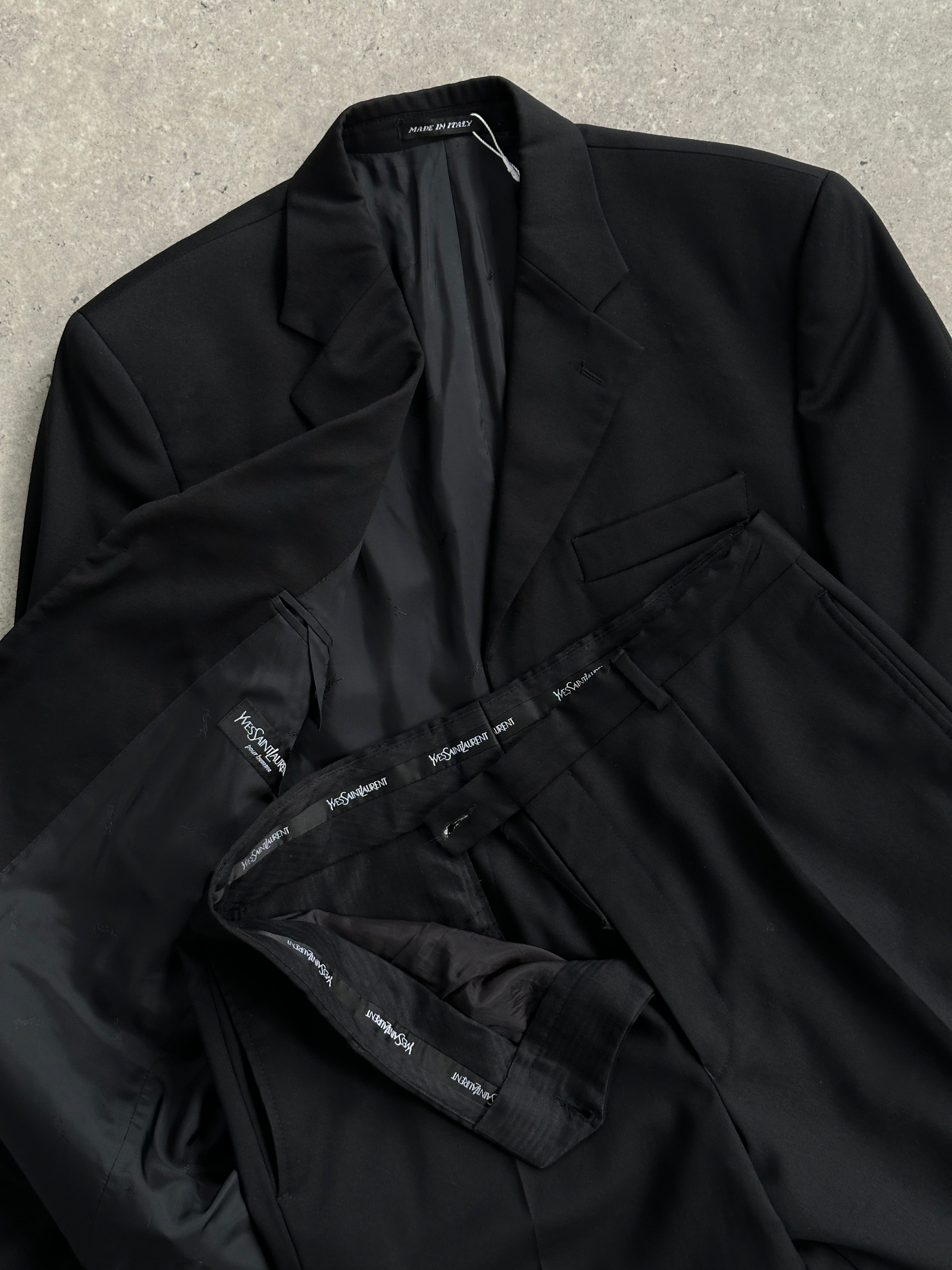 Yves Saint Laurent Pour Homme pure wool single-breasted suit in size 42R/W34, displayed on a hanger with a classic fit.