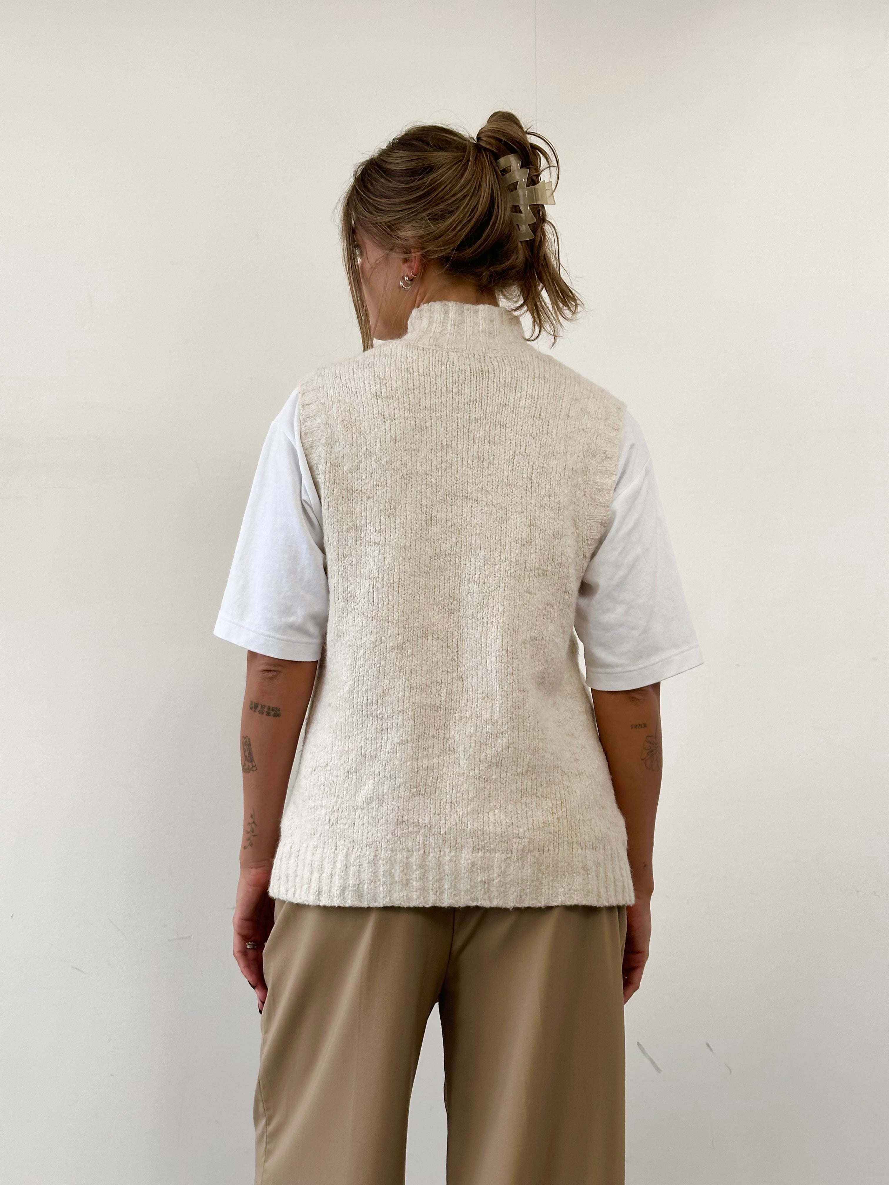 L.L. Bean wool sleeveless knitted cardigan in size L, beige color, showcasing a cozy, sleeveless design with knitted texture.
