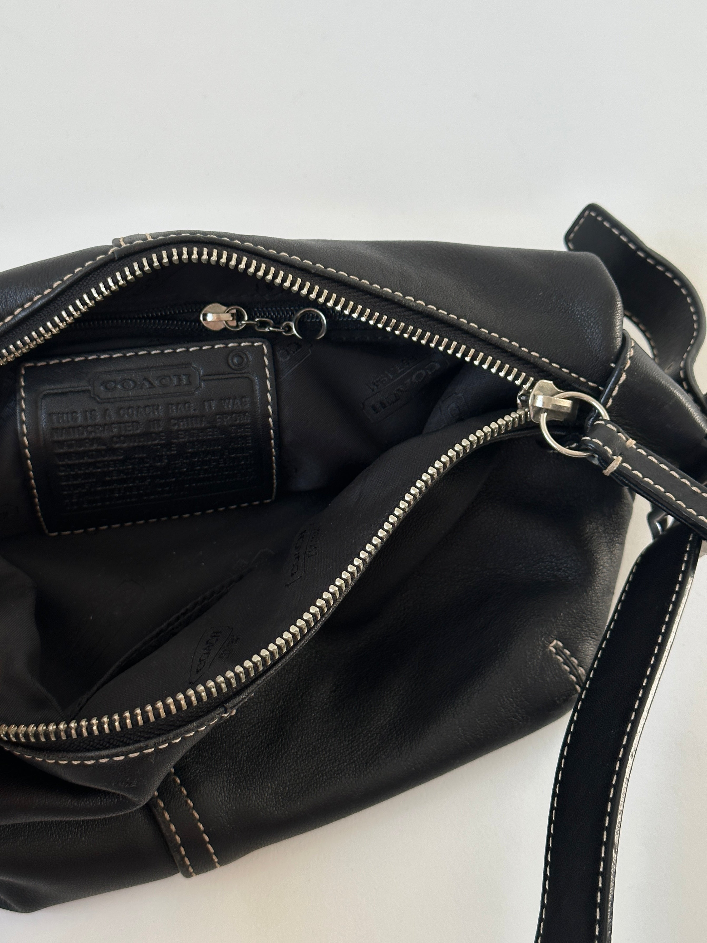 Coach 2000s leather shoulder bag with contrast stitching, featuring a classic design and adjustable strap.