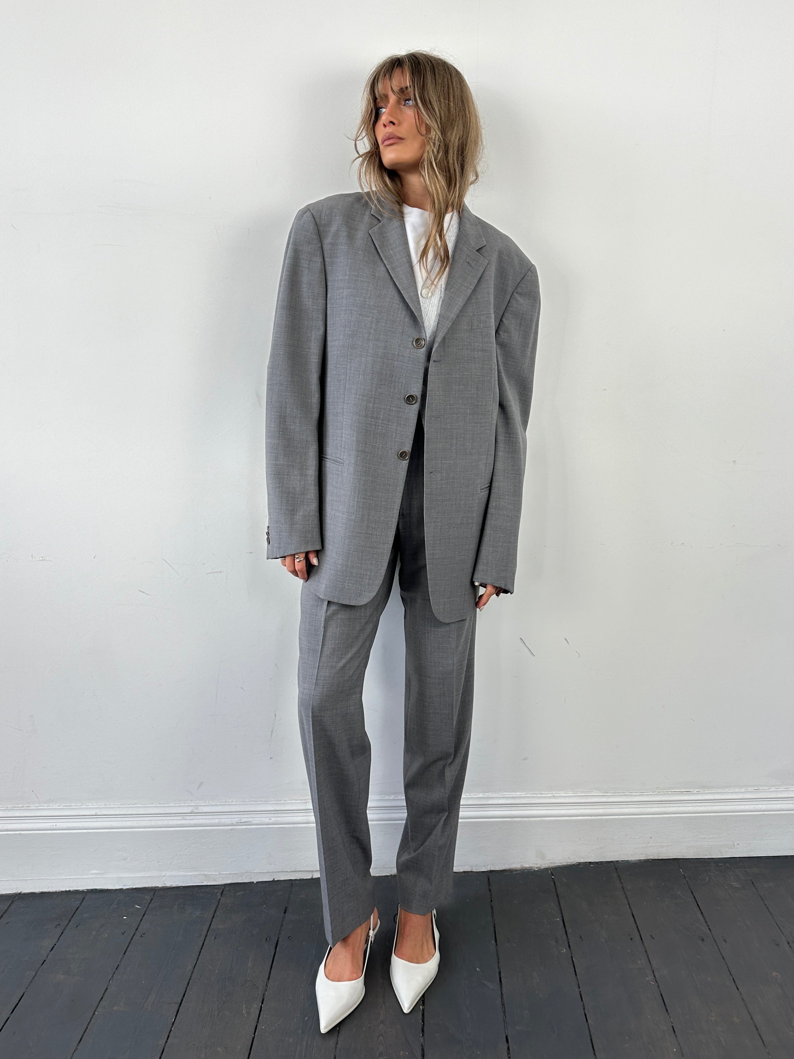 Armani Collezioni relaxed virgin wool single-breasted suit jumpsuit in size 40R/W32, displayed on a hanger.