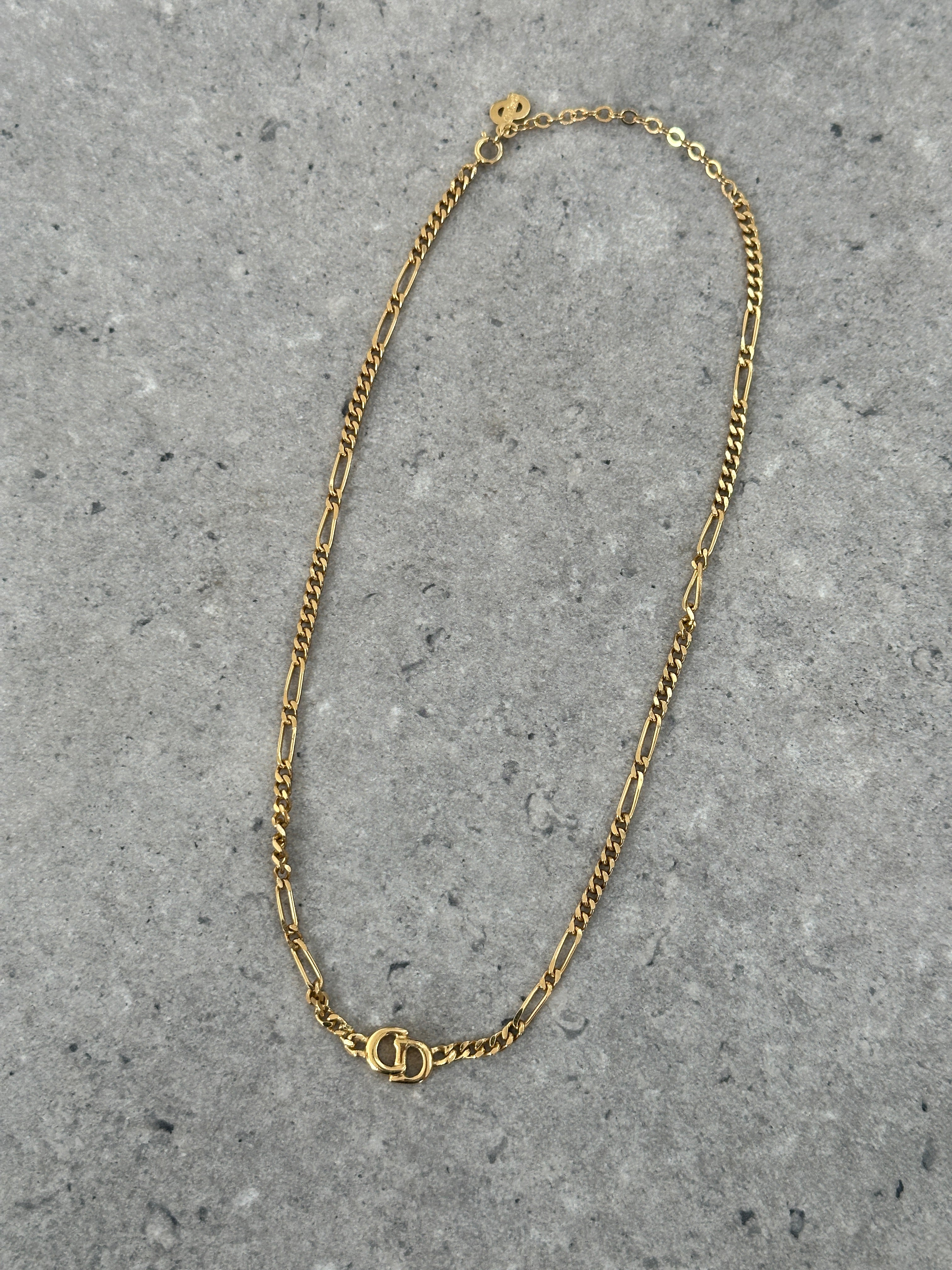 Christian Dior 18-inch gold-plated logo pendant necklace featuring a stylish chain and prominent Dior logo charm.