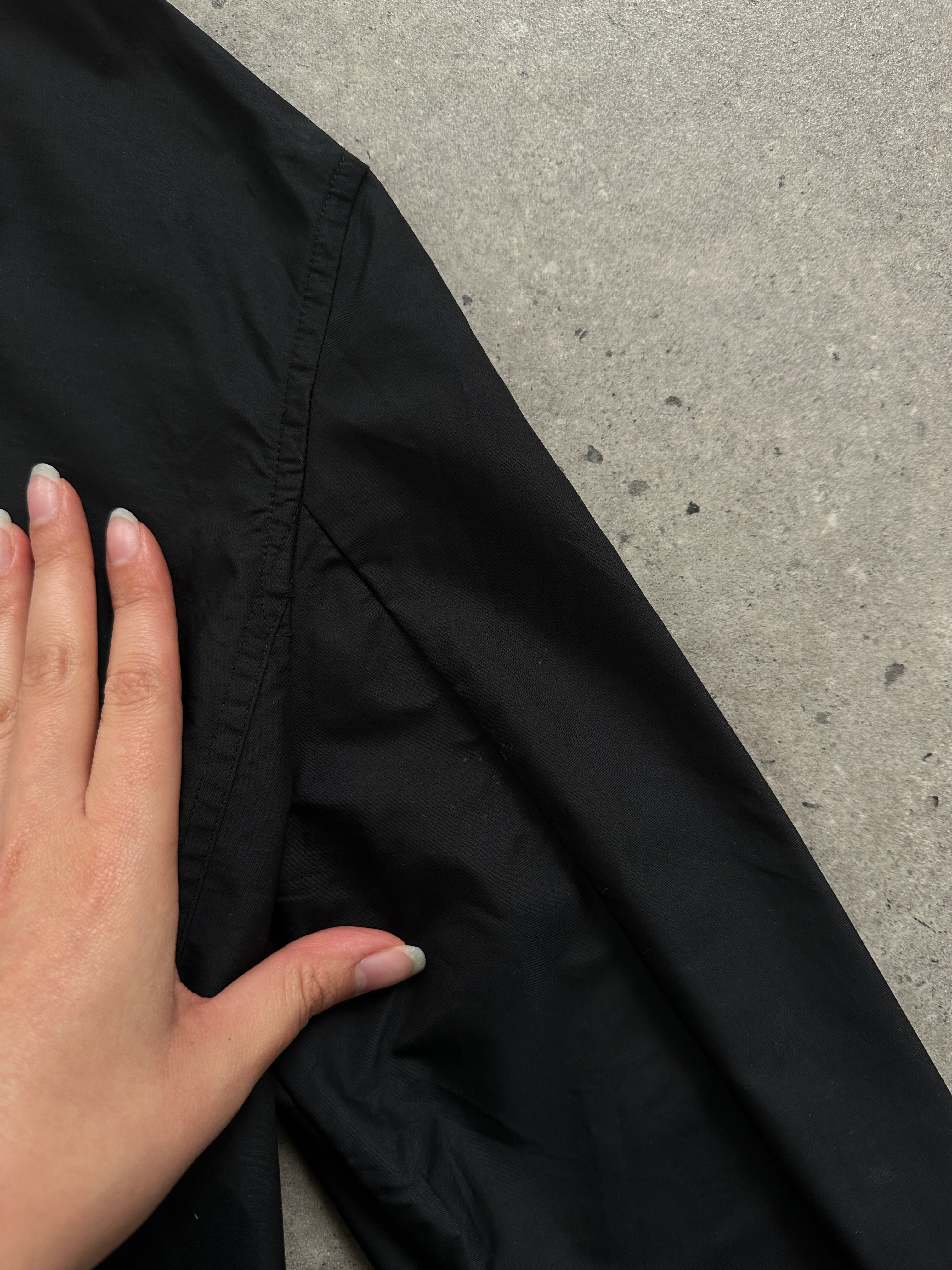 Max Mara Weekend black bomber jacket with concealed placket, ribbed cuffs, and collar, displayed on a hanger.