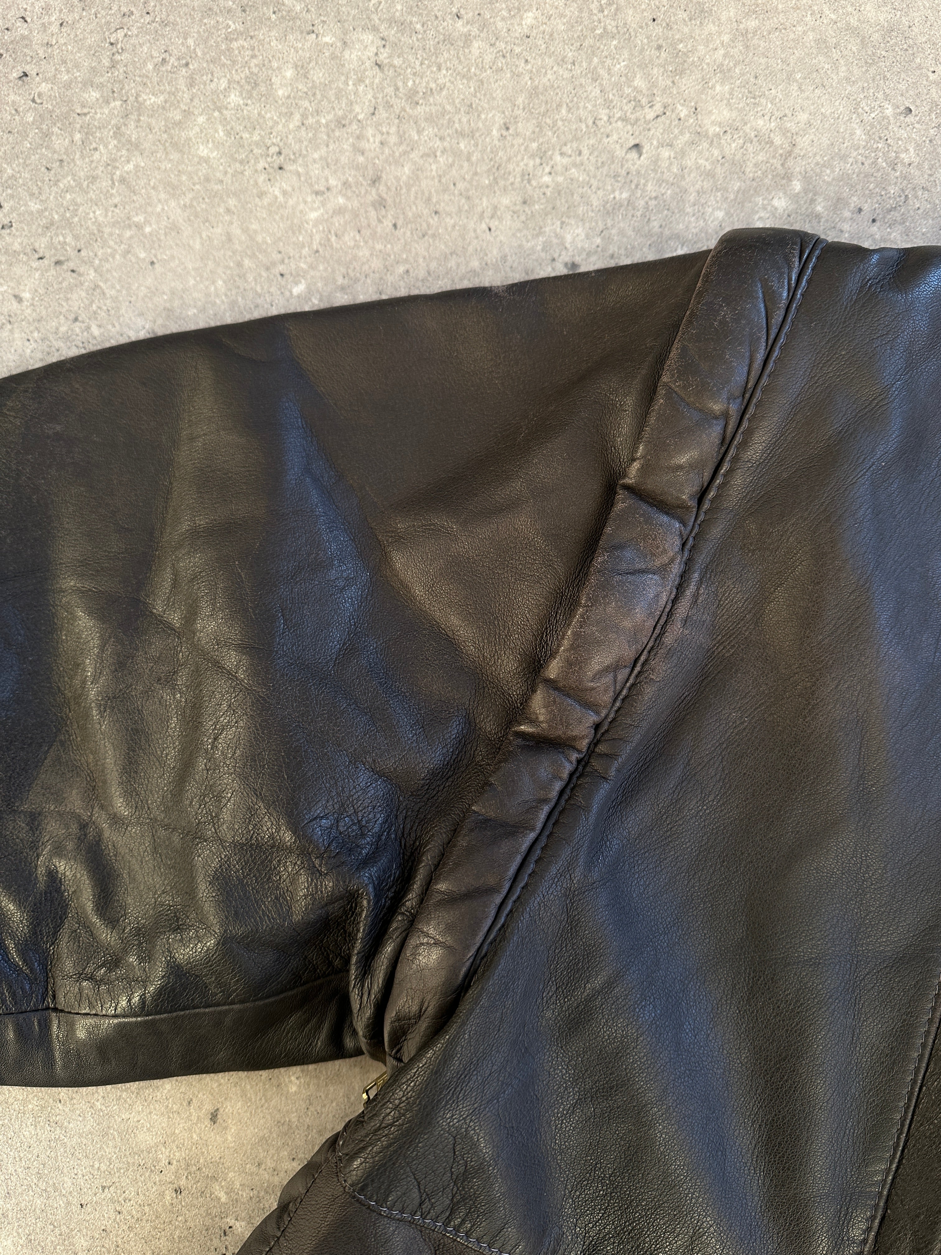 Vintage leather bomber gilet jacket in size M, featuring classic design and textured leather, worn by a model.