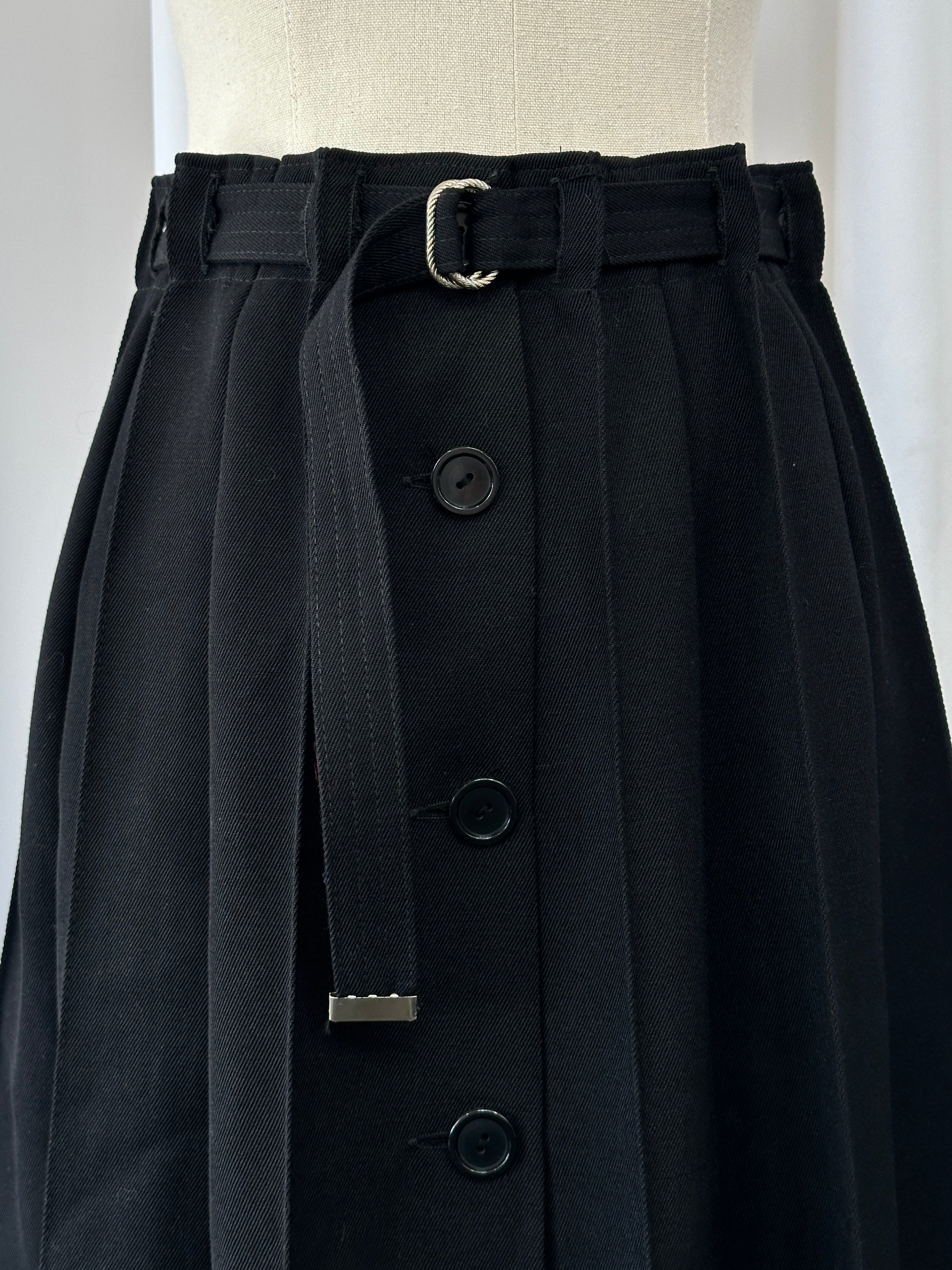 Vintage 1990s wool pleated midi skirt in deep green, featuring classic pleats and a high waist, size W26.