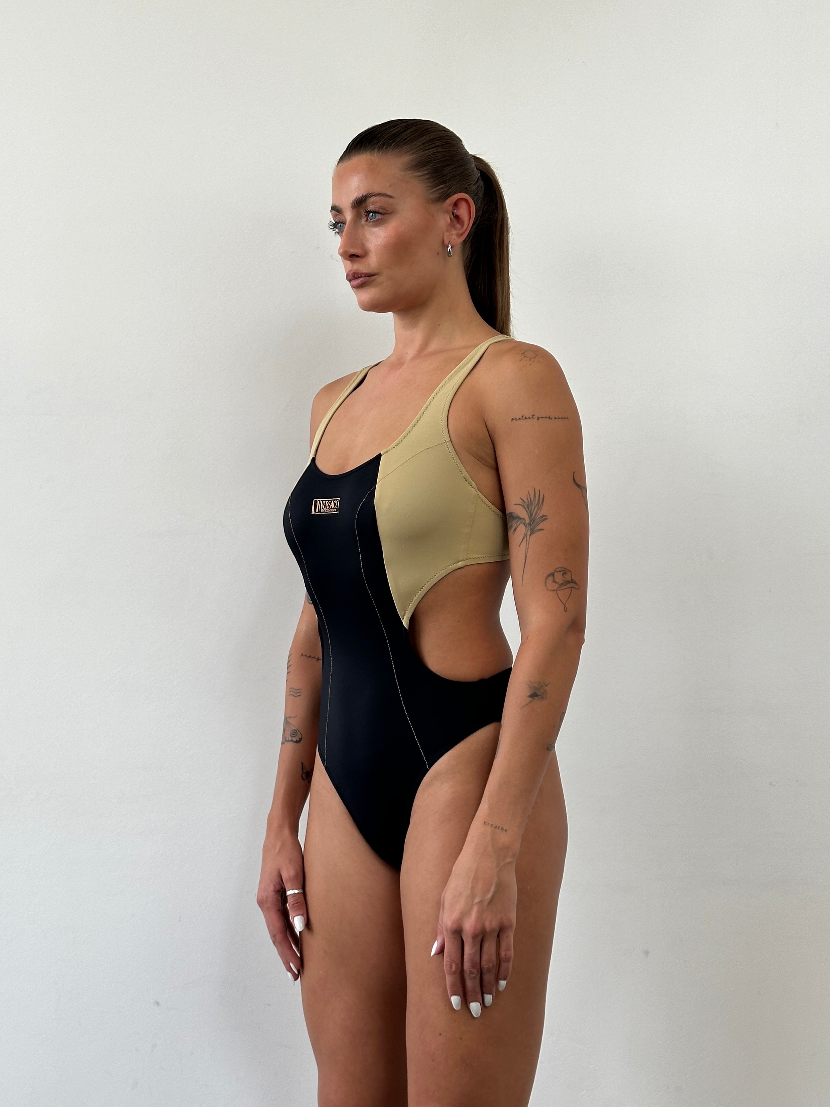 Versace Intensive 1990s high-cut logo one-piece swimsuit top in black with bold branding and sleek design.
