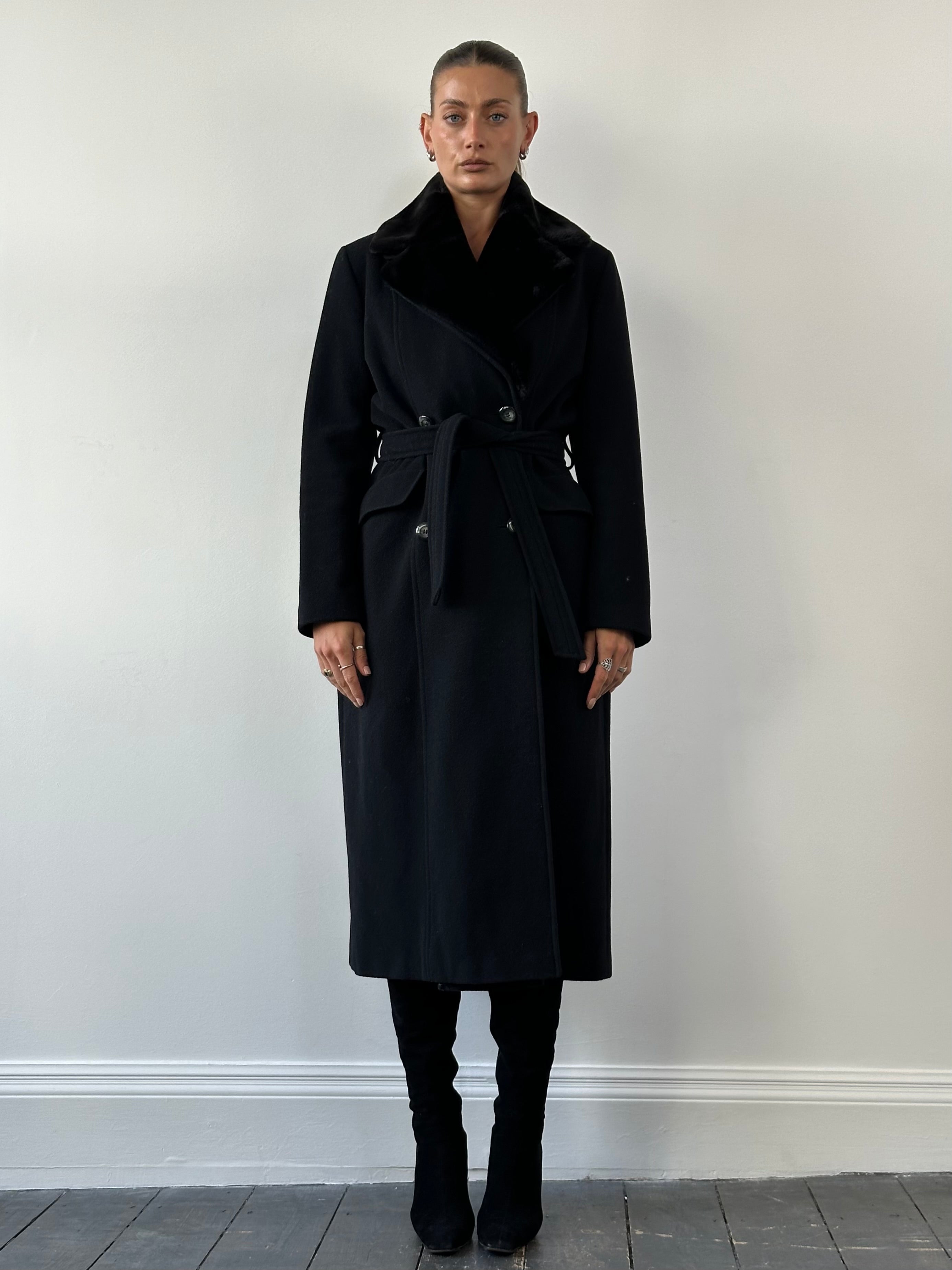 Vintage wool coat with removable faux fur collar, belted, in a classic design, shown in a natural outdoor setting.