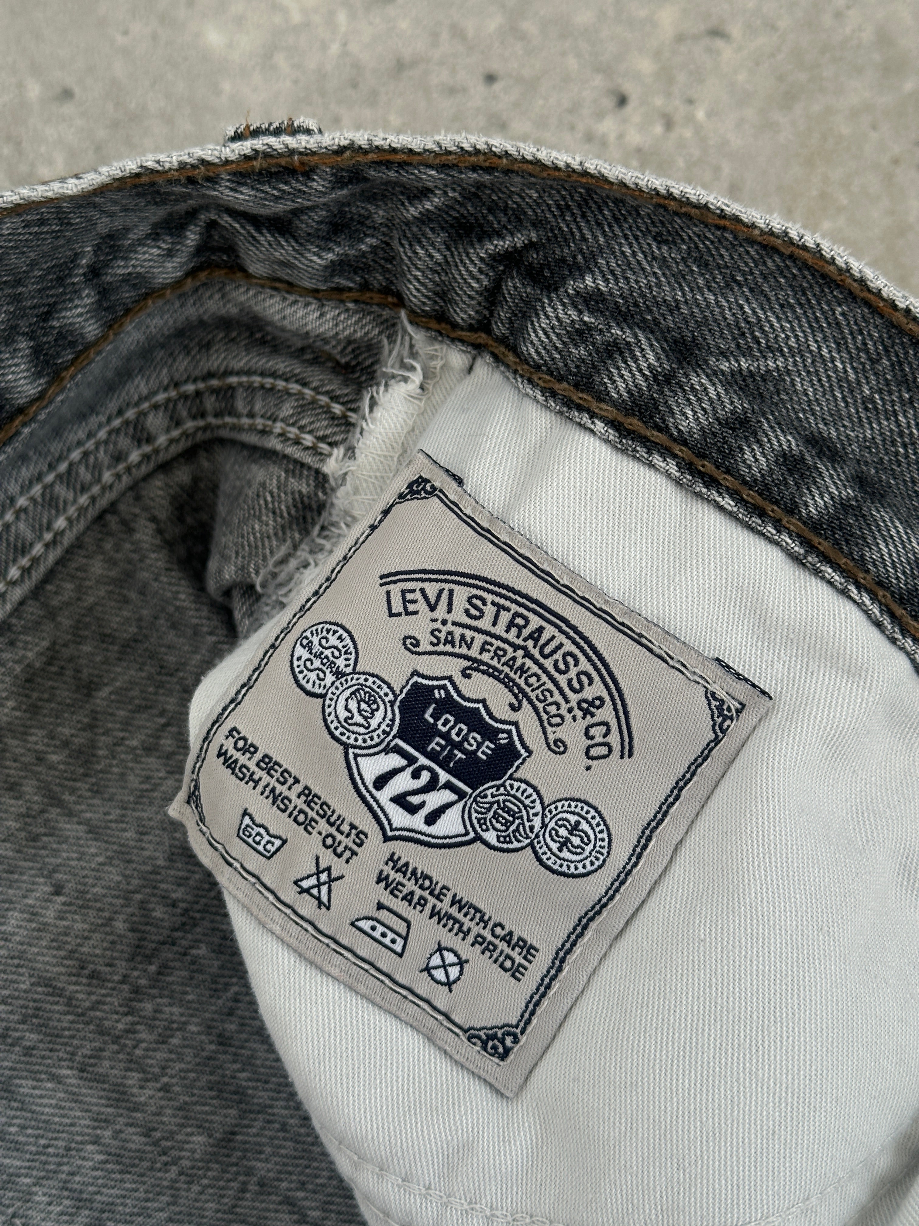Levi’s 80s 727 Silver Tab loose fit denim jeans in W30, showing distressed light wash fabric and relaxed fit style.
