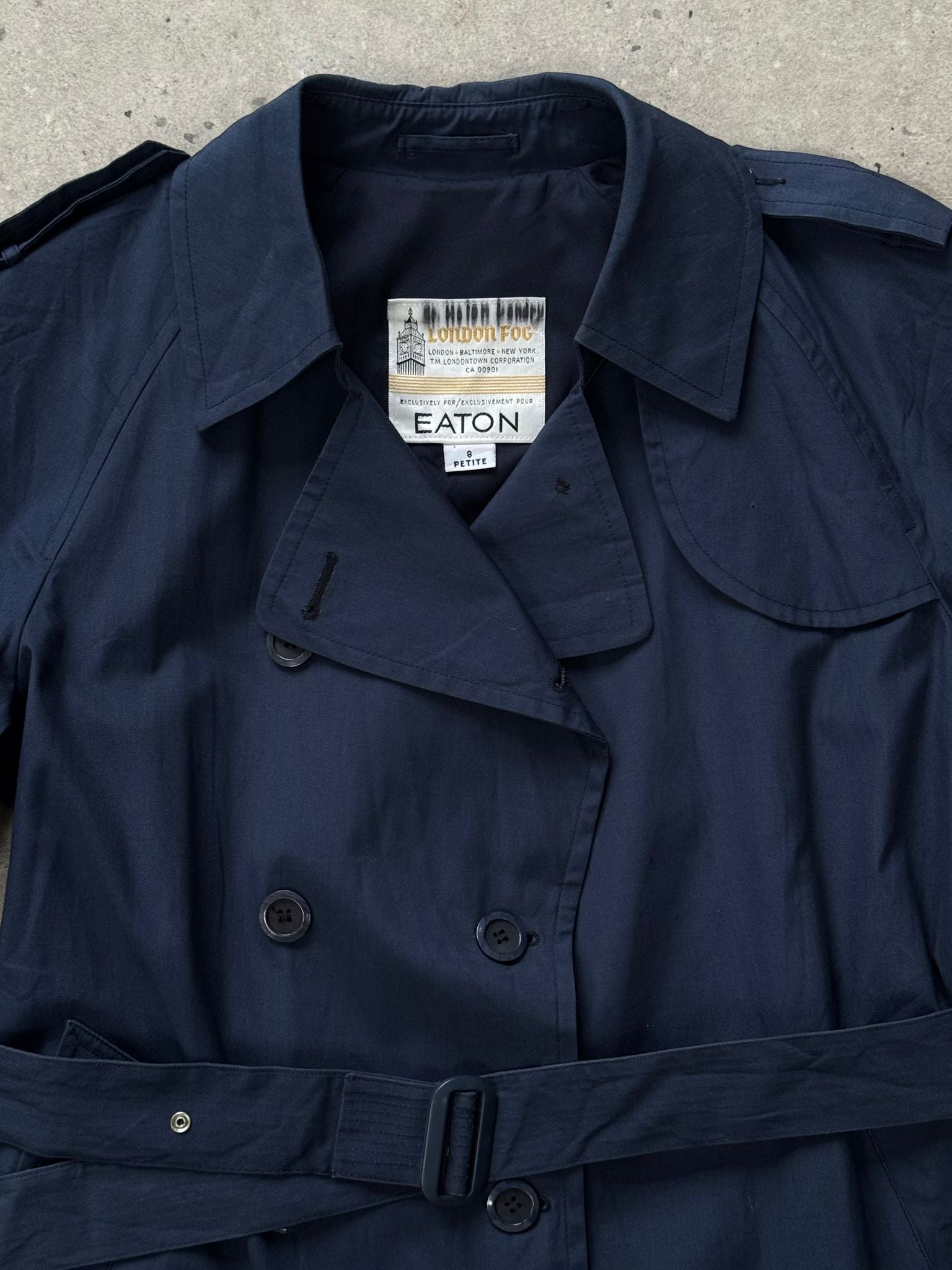 London Fog 1990s double-breasted cotton trench coat in S/M size, showing classic beige fabric and belt detail.