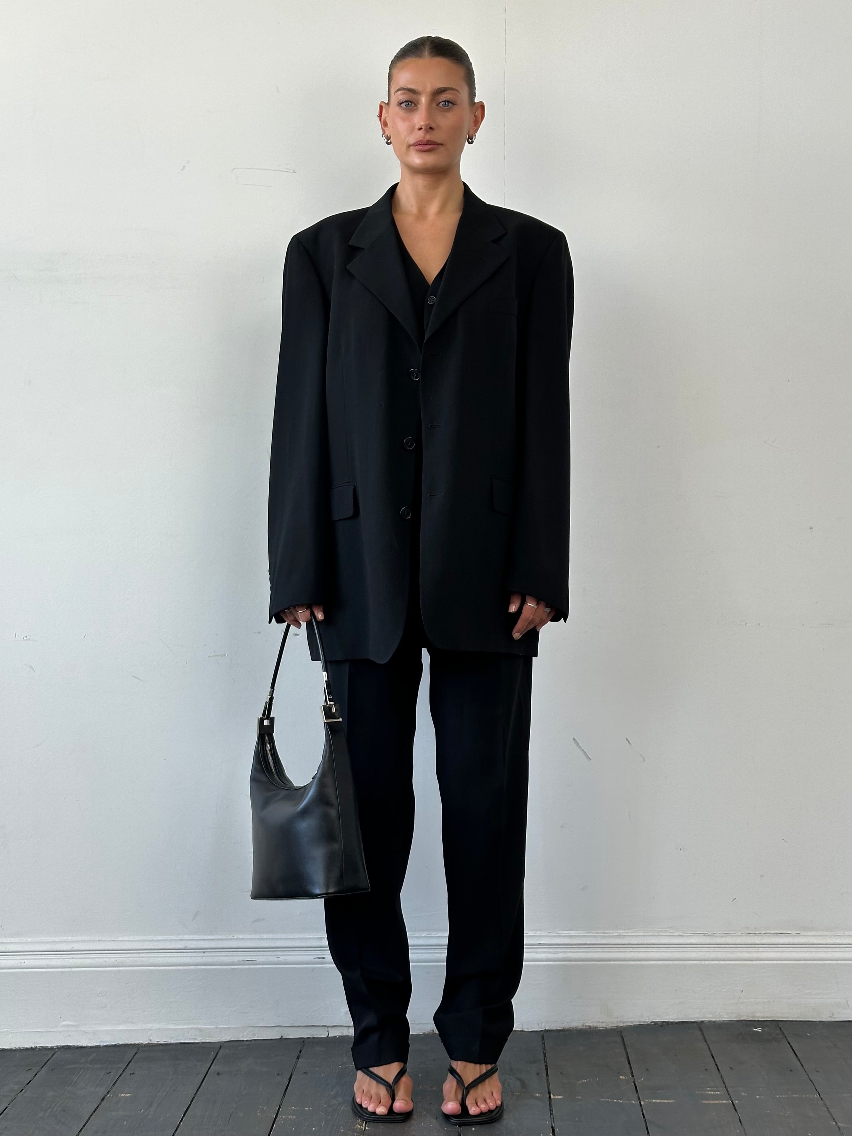 Yves Saint Laurent Pour Homme three-piece wool suit, tailored in size 46L/W34, shown on a hanger with jacket, shirt, and trousers.