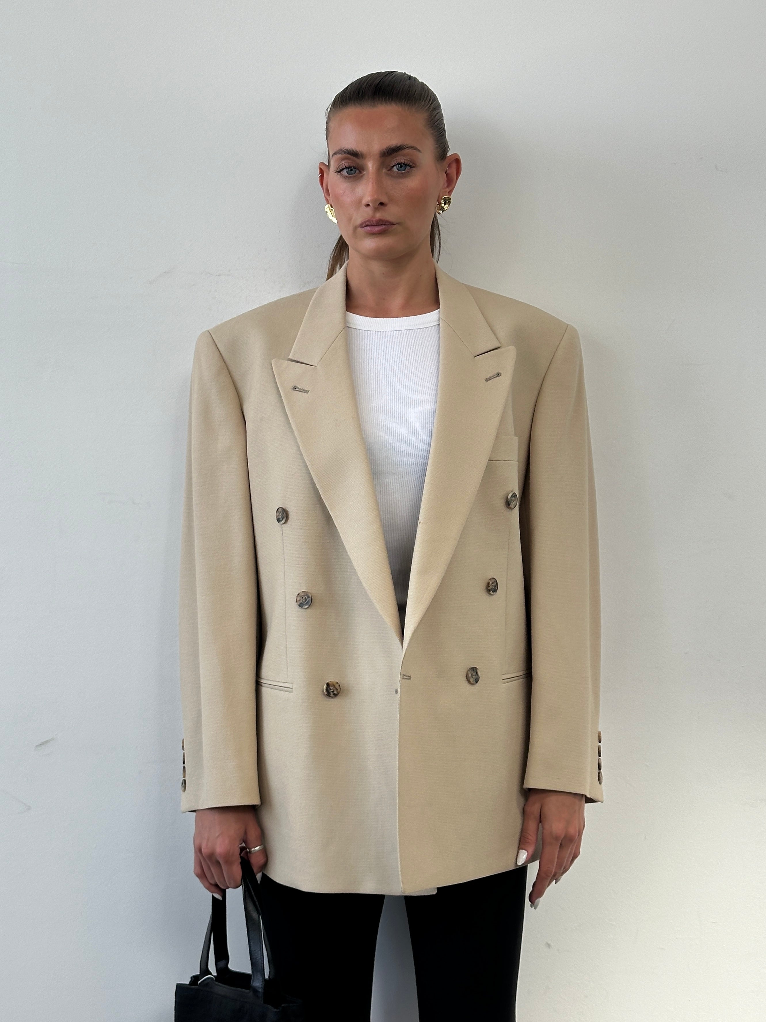 Vintage wool double-breasted blazer in size 40R/L, featuring classic tailoring and textured fabric, modeled on a hanger.