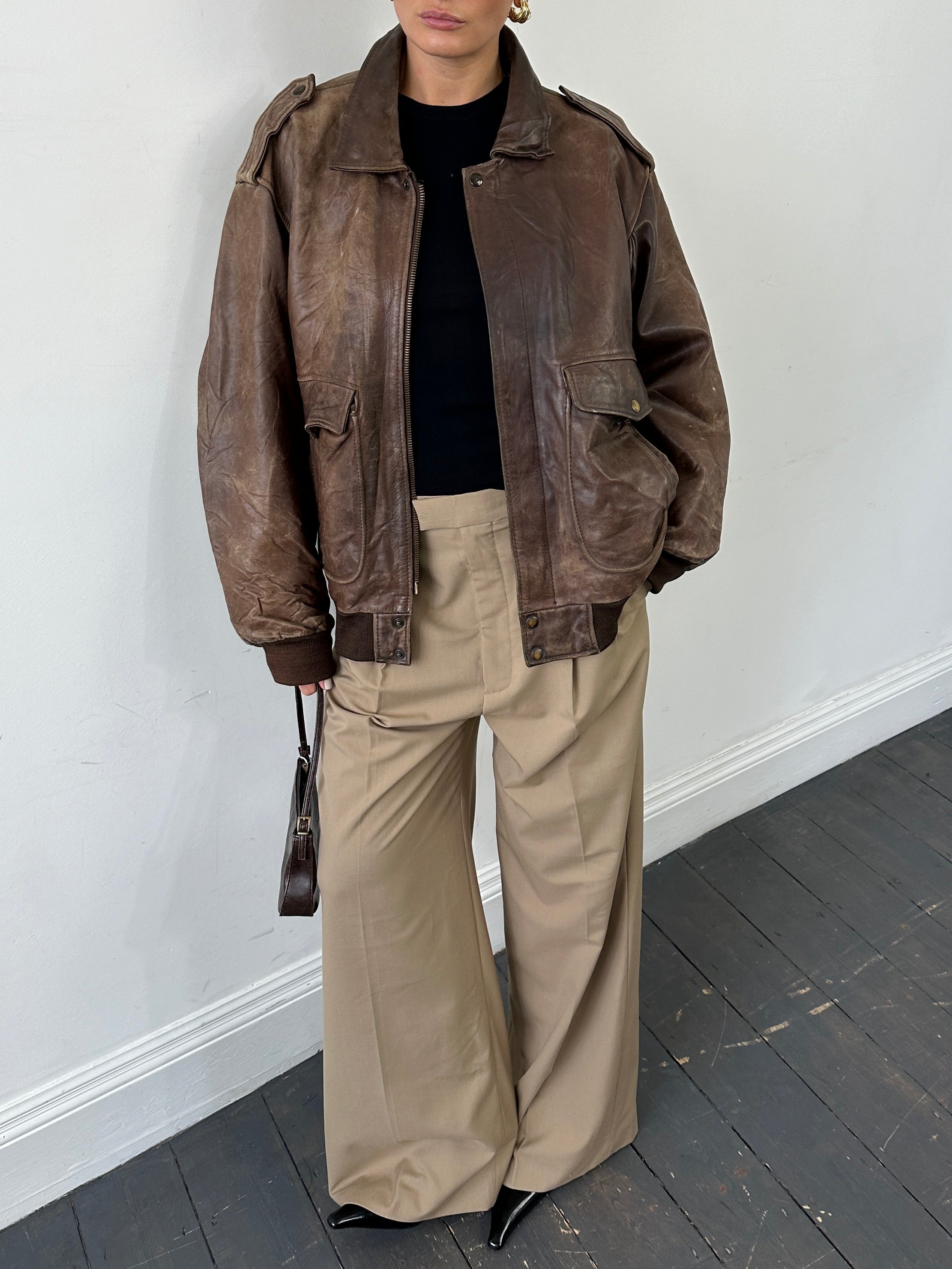 Vintage distressed leather bomber jacket in XL with rugged style, featuring a classic fit and weathered leather appearance.