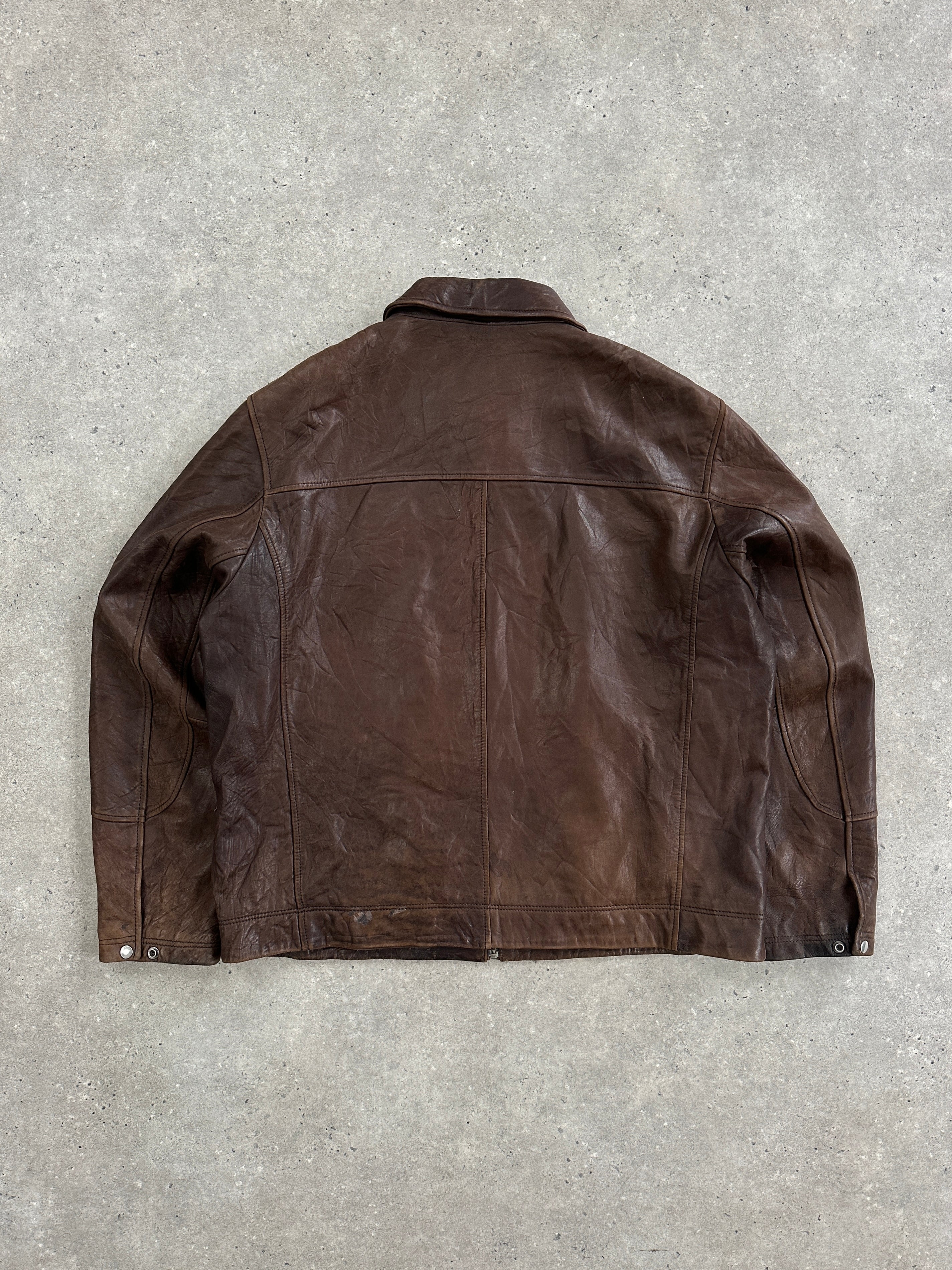 Vintage 1990s distressed leather jacket in XXL size, featuring rugged style and authentic worn-in leather.