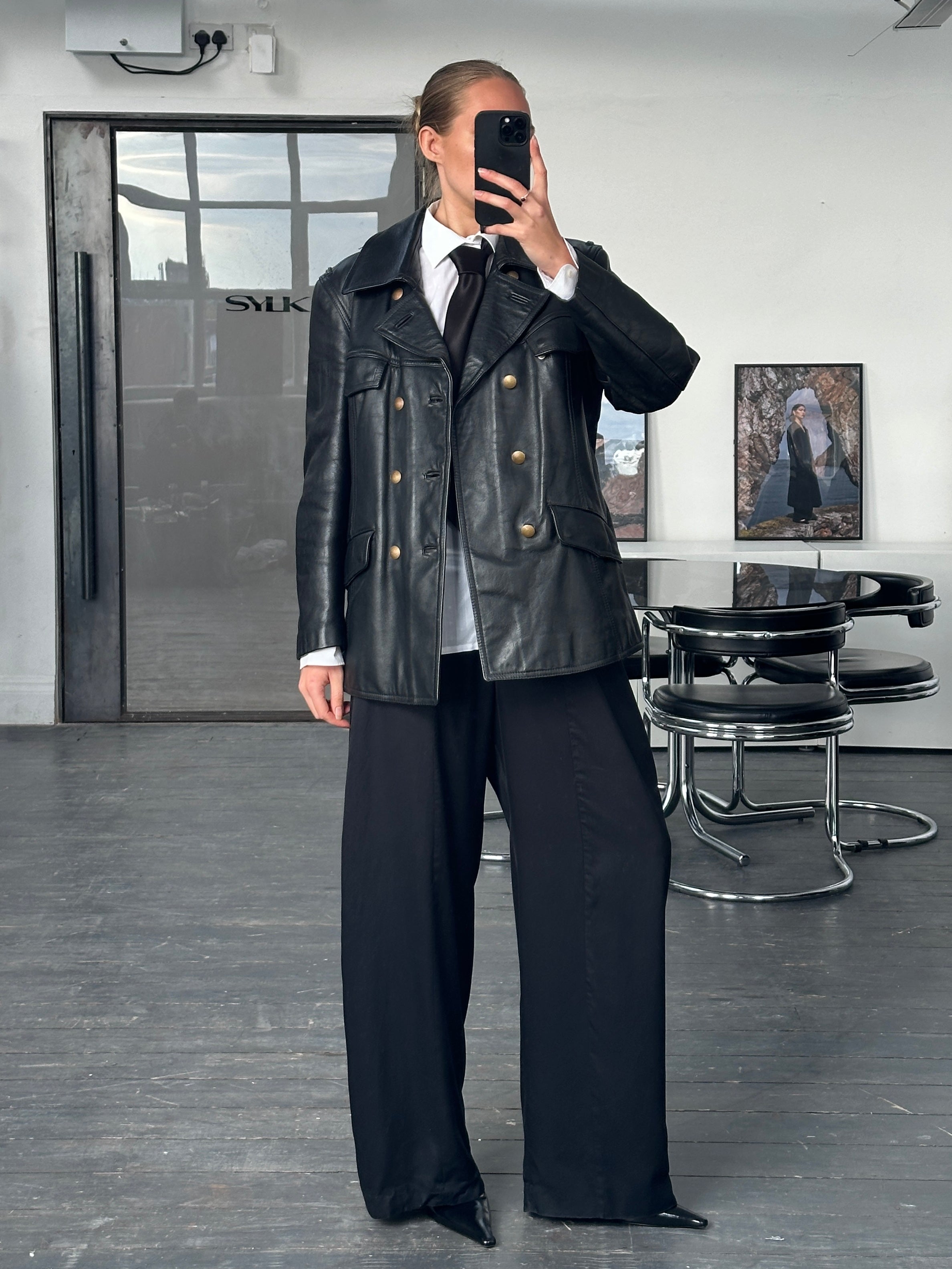 Vintage 1980s double-breasted military leather jacket, showcasing structured design and classic brown leather, size M/L.