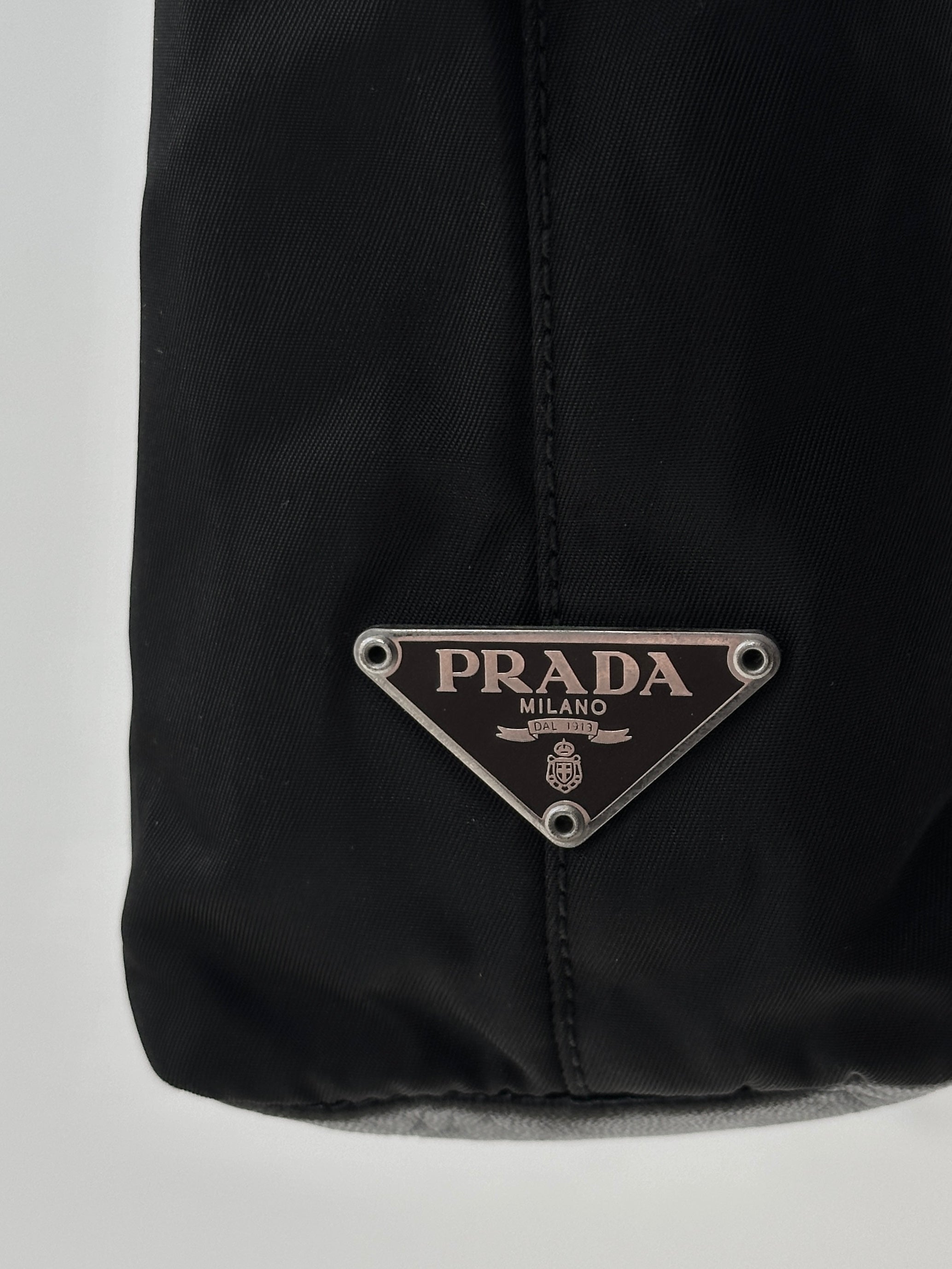 Prada nylon and leather tote bag with sleek design, featuring sturdy handles and spacious interior for everyday use.