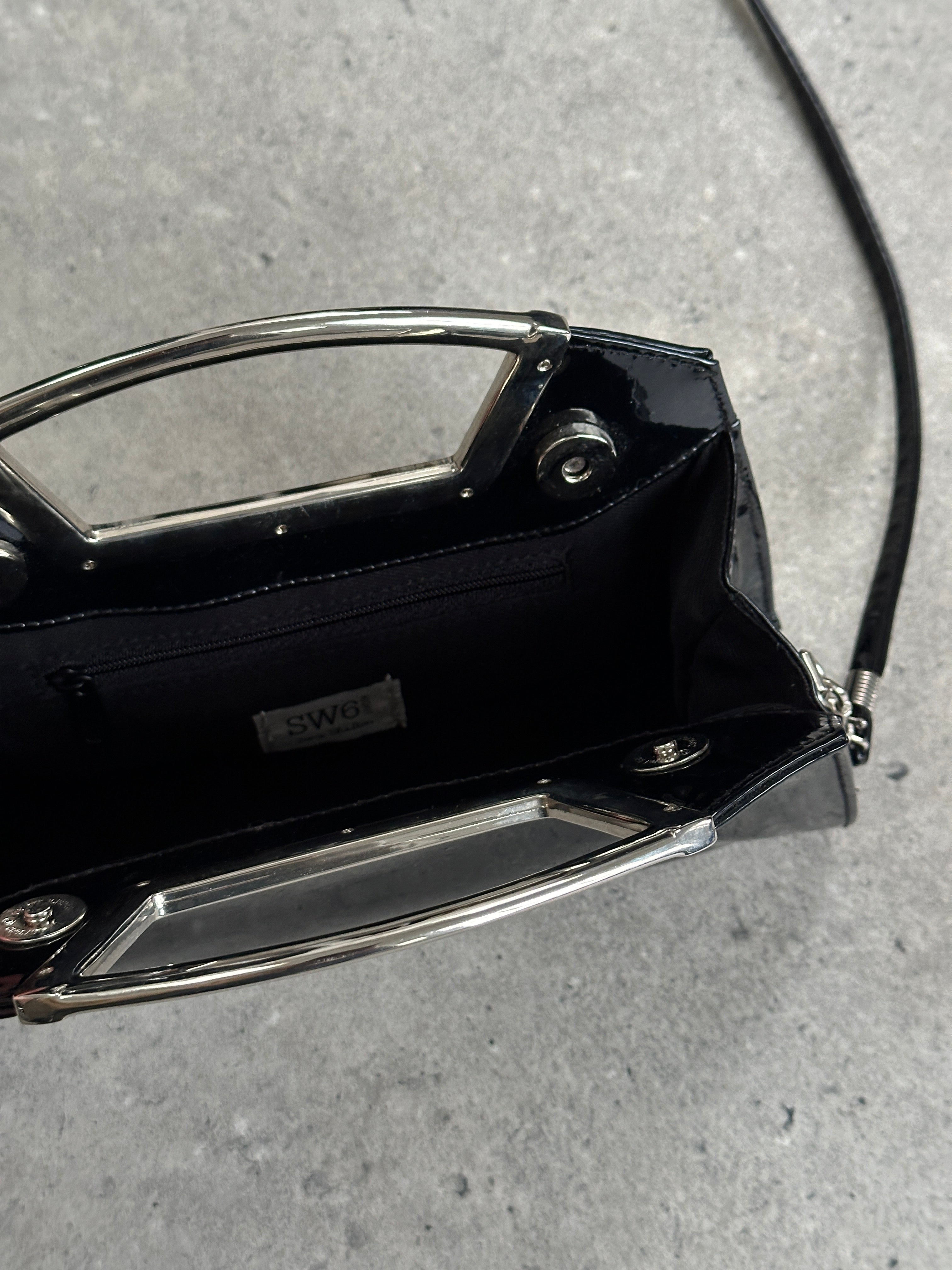 Vintage 2000s patent vinyl chrome crossbody clutch bag with metallic finish and sleek design.