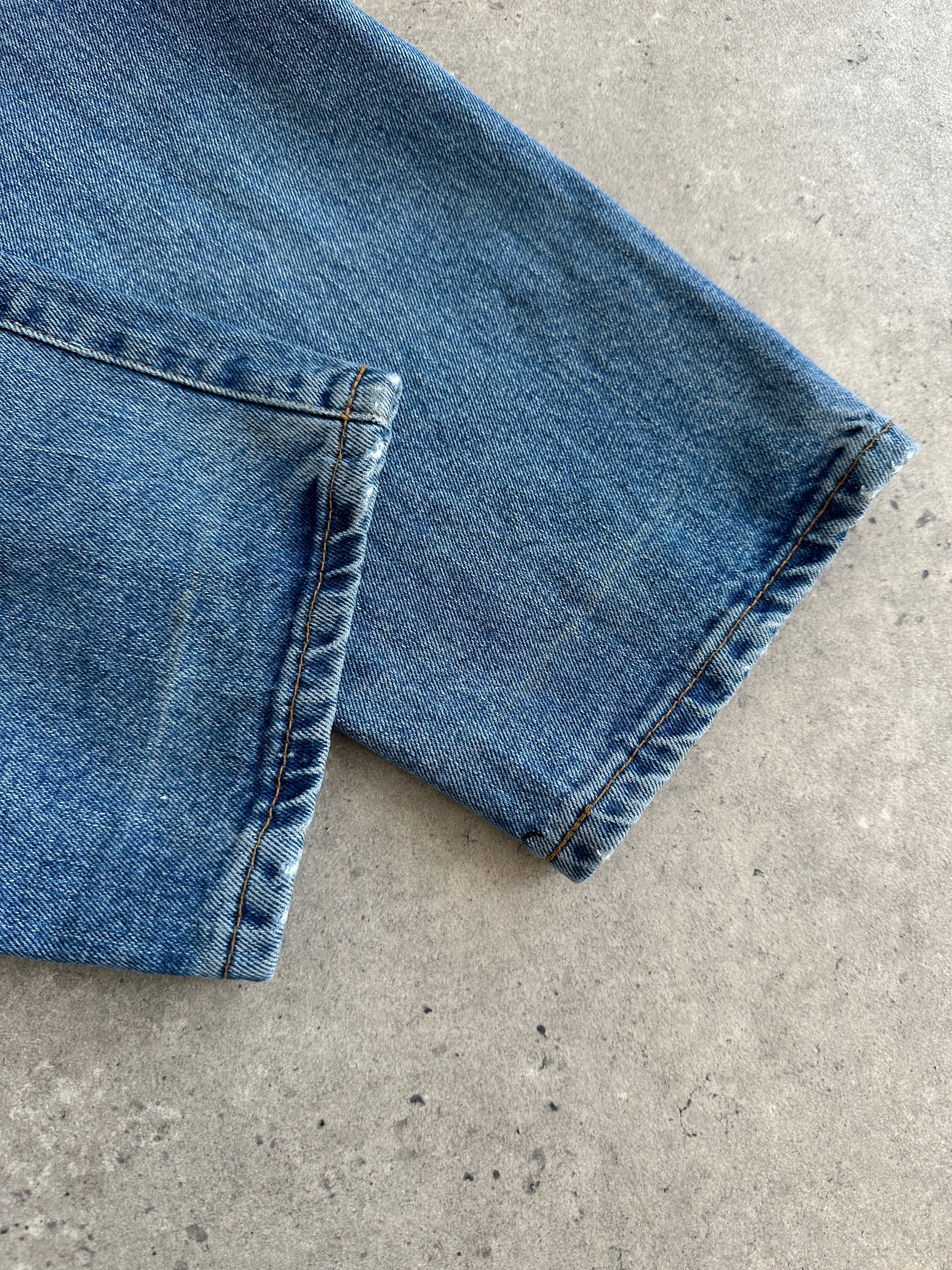 Armani Jeans mid wash tapered leg high waisted denim jeans, front view with classic five-pocket design and belt loops.
