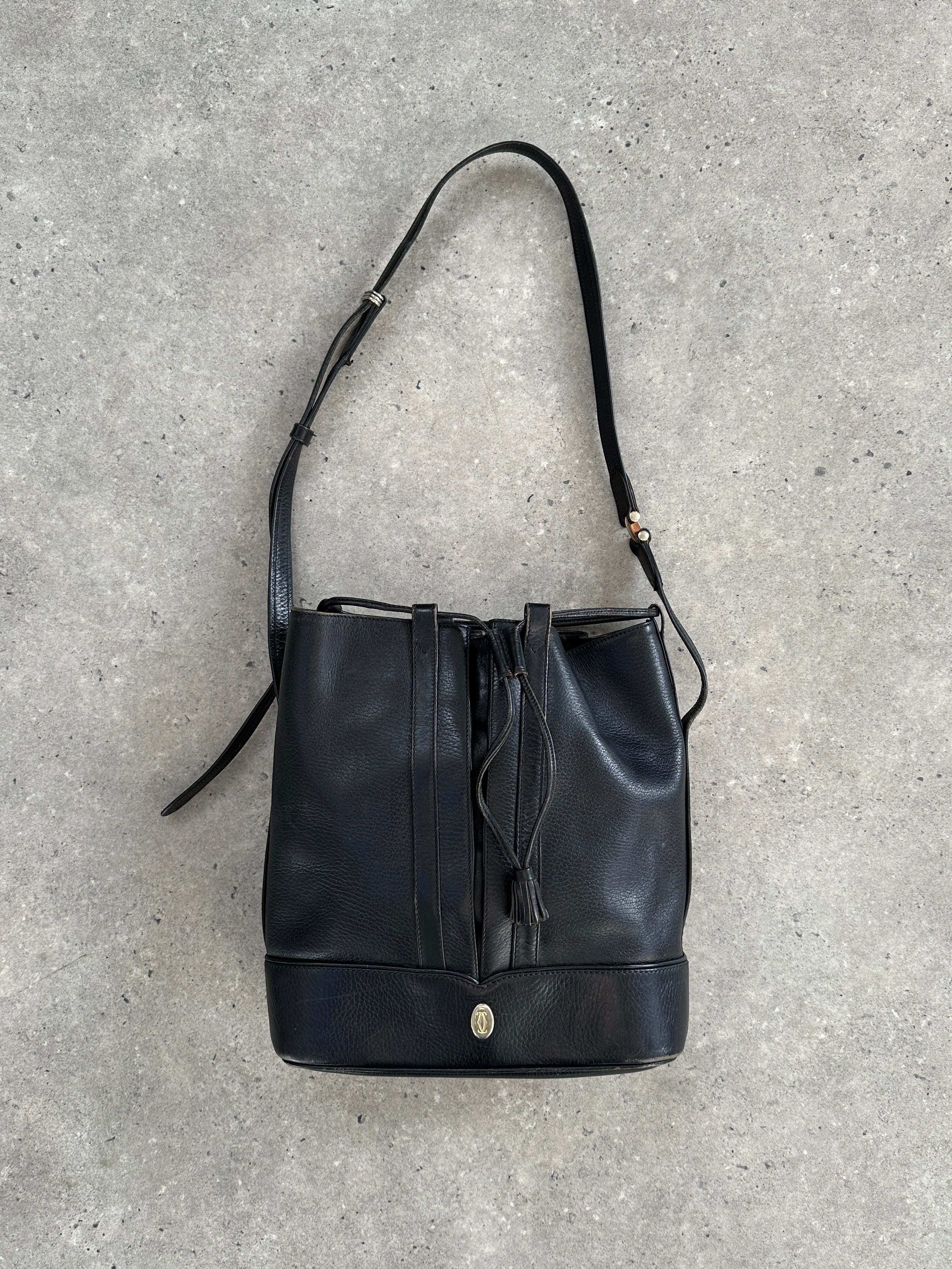 Cartier 1980s leather bucket bag with adjustable strap and gold-tone hardware, vintage style accessory.