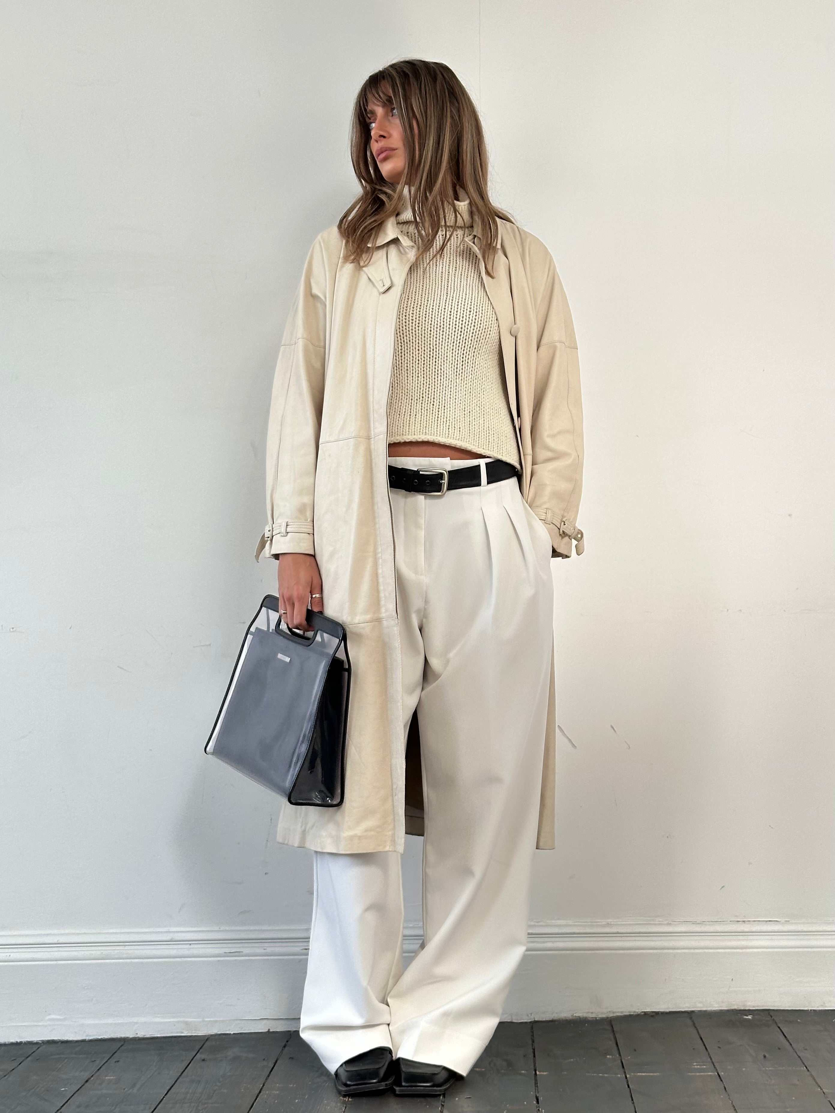 Vintage leather trench coat with belt, classic trench jacket style, in M/L size, showcasing durable leather and timeless design
