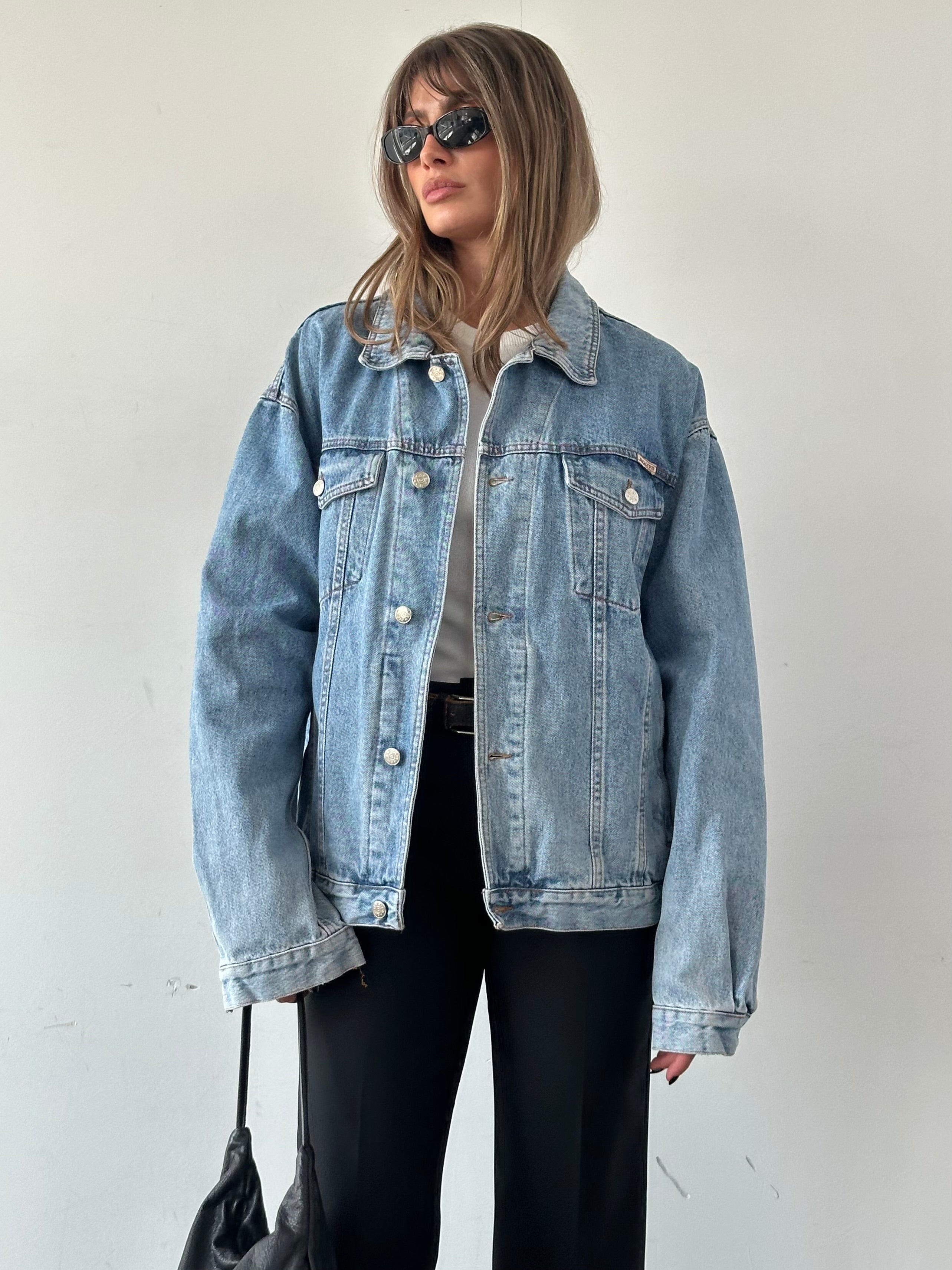 Vintage oversized denim jacket in XL, shown with classic blue wash, button closure, and relaxed fit.