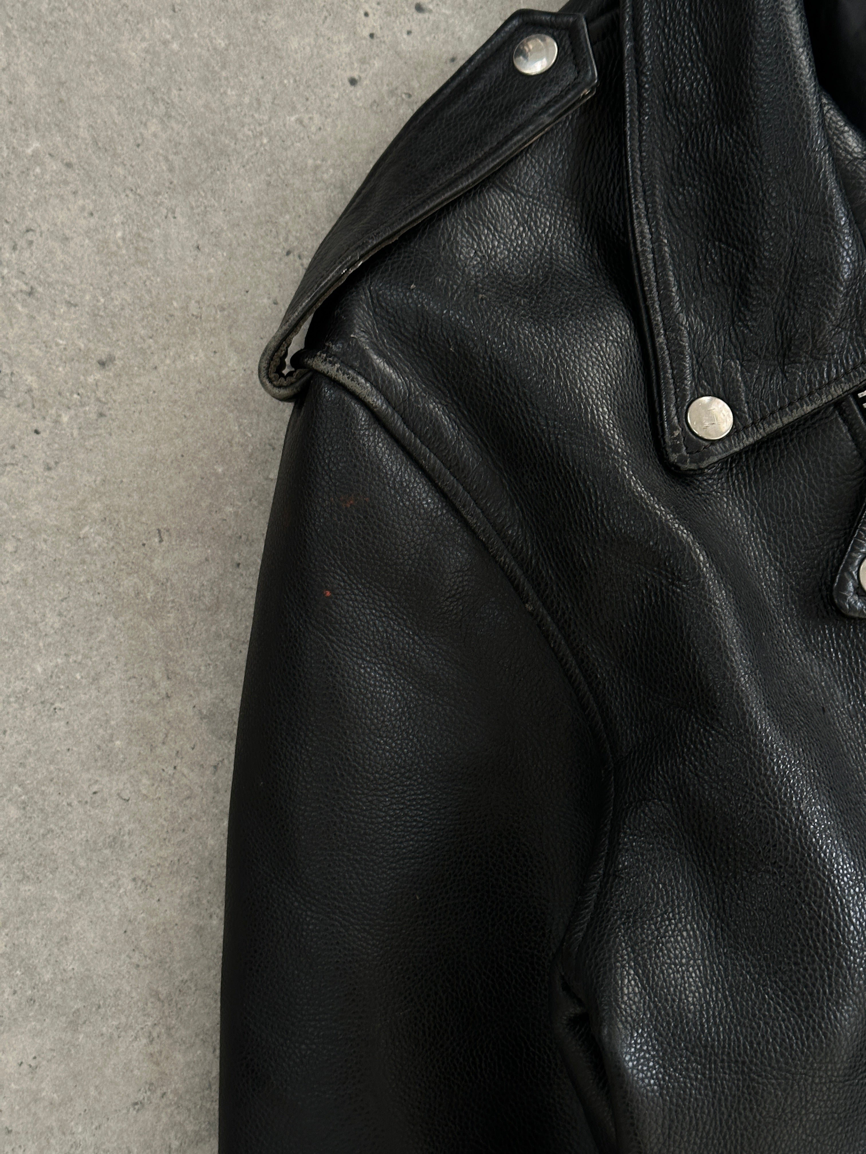 Vintage leather biker jacket in XL size featuring classic design with rugged texture and detailed stitching.