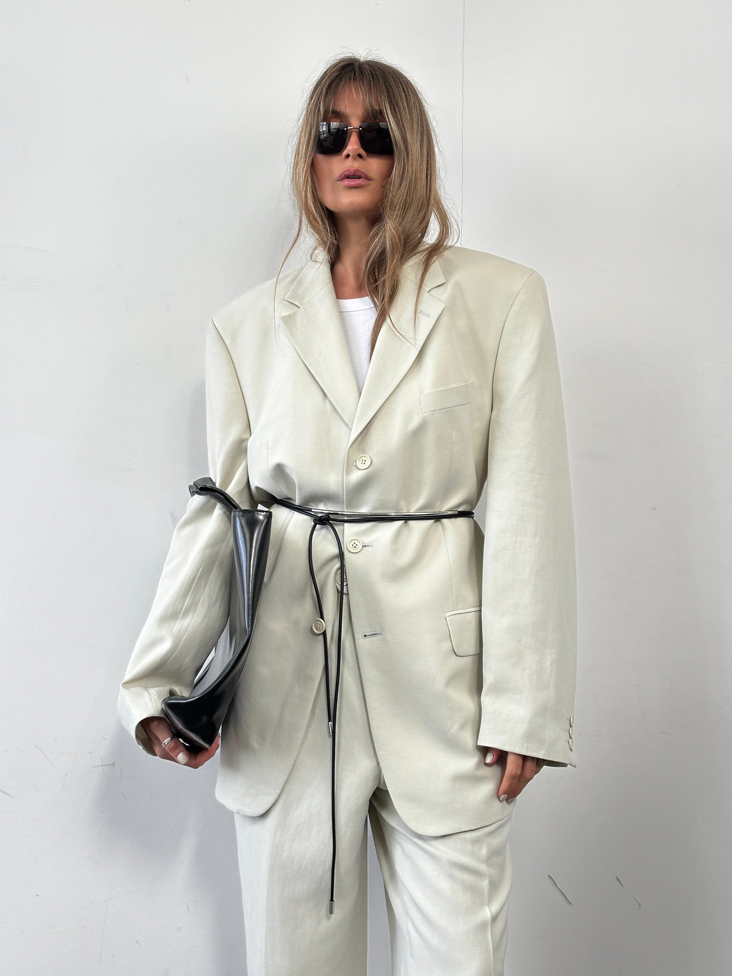 Pierre Cardin linen Tencel single-breasted jumpsuit in size 42L/W34 laid flat, showcasing its tailored fit and fabric details.