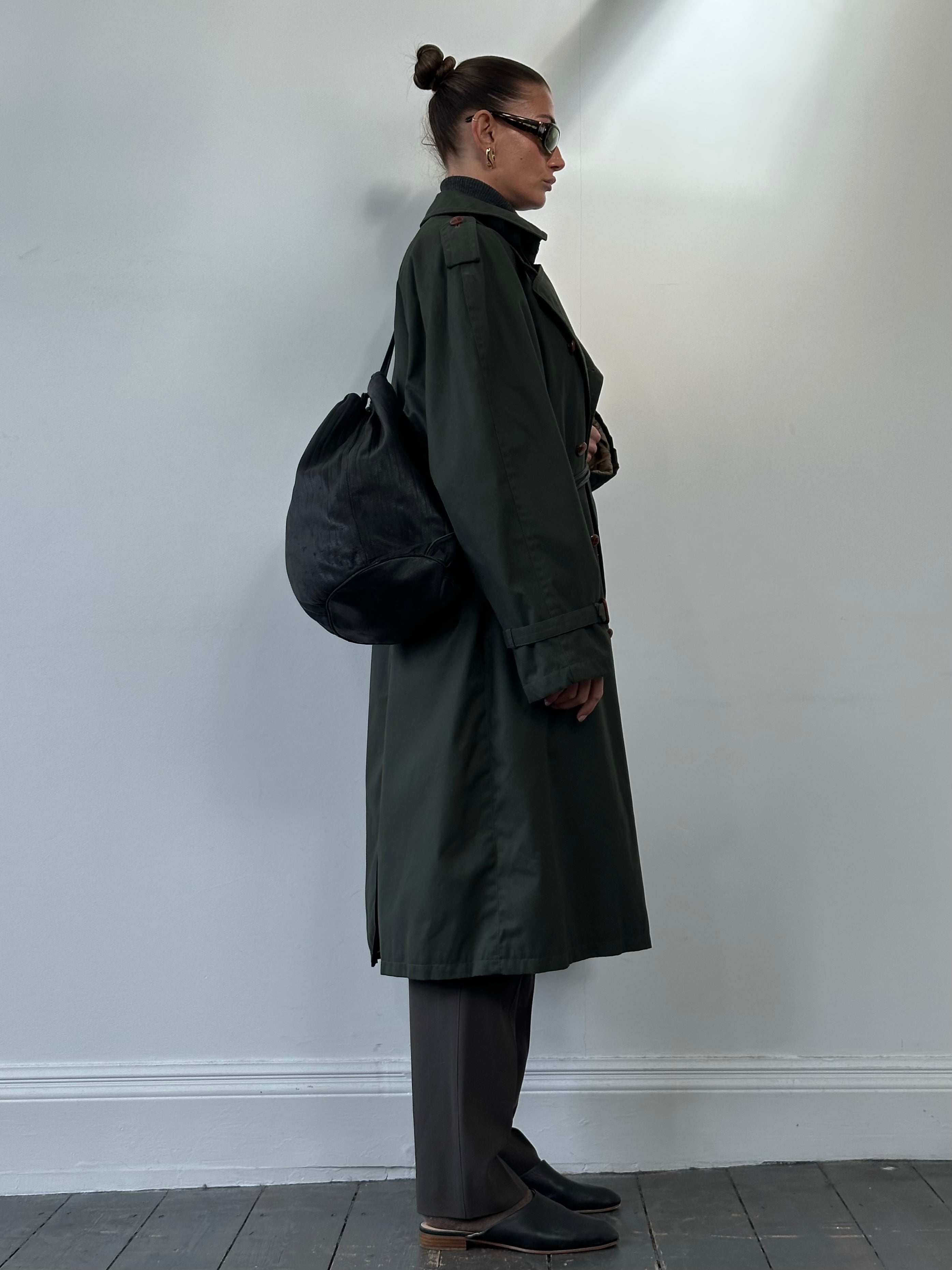 Giorgio Armani Le Collezioni leather rucksack bag with adjustable straps and sleek design, featuring the Armani logo.