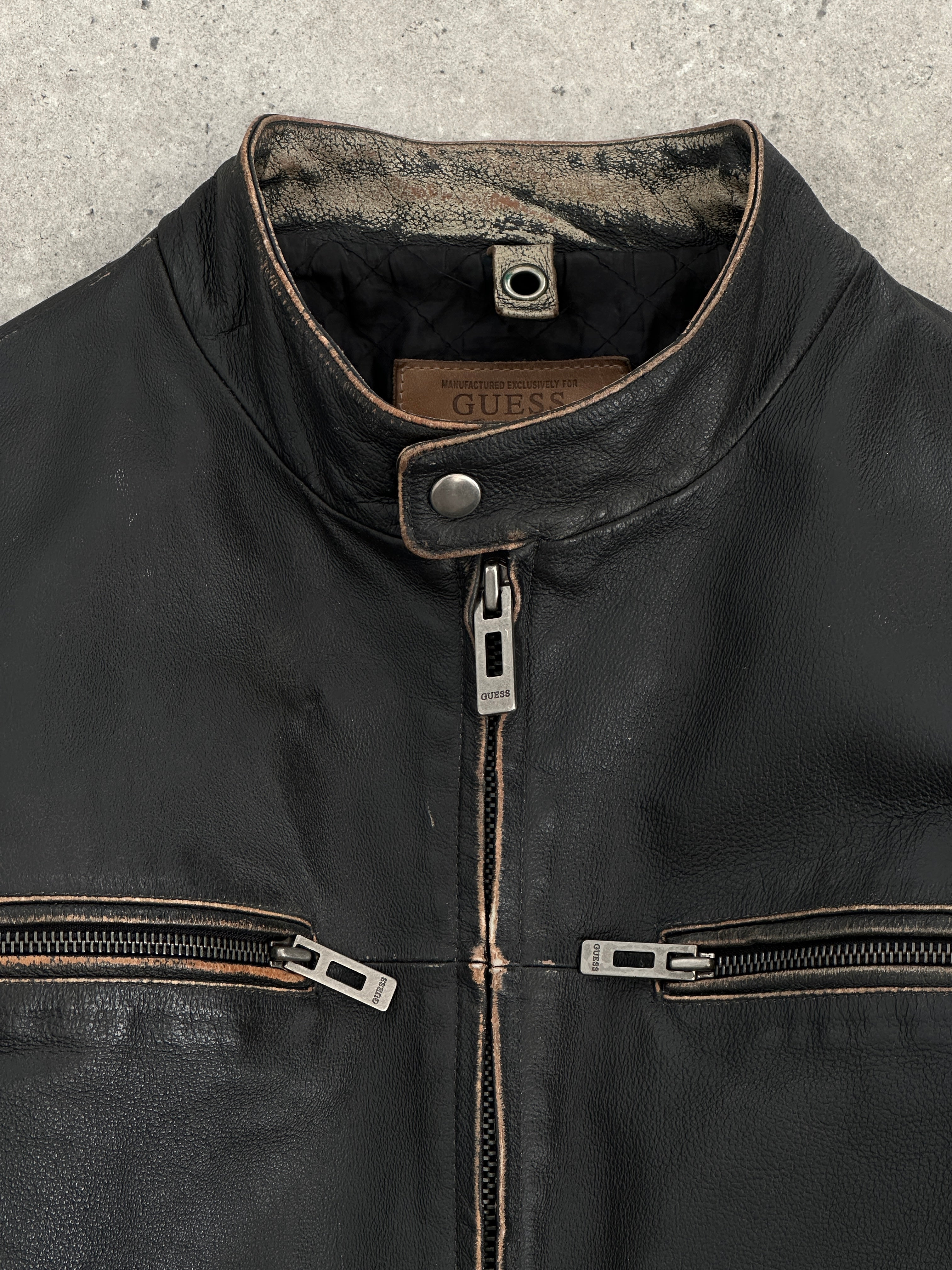 Guess distressed moto leather jacket in size L, featuring a stylish, worn-in look with signature branding and classic motorcycle design.