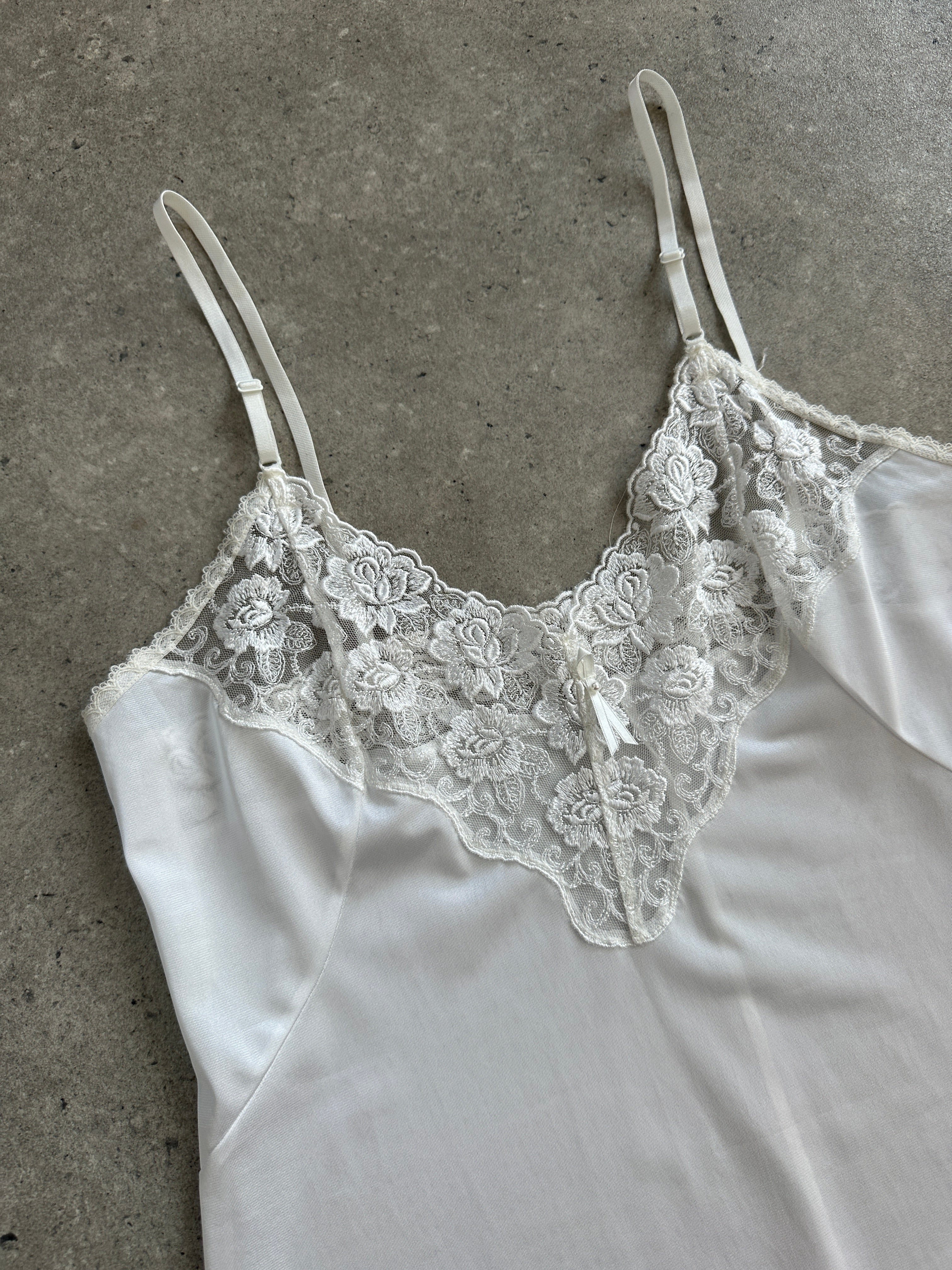 Vintage 1990s lace sheer mini slip dress in size small, featuring delicate lace details and a vintage-inspired design.