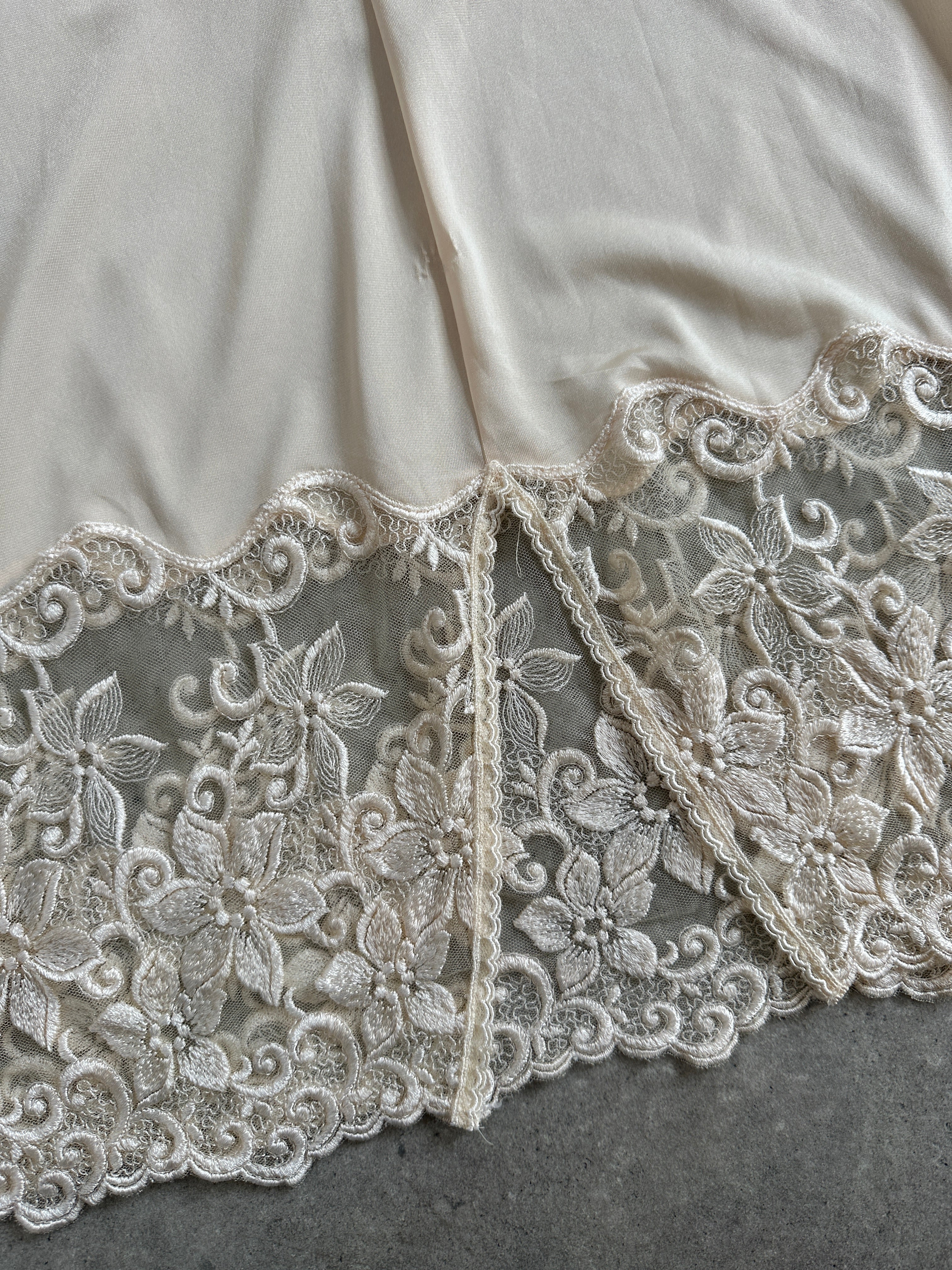 Vintage 1990s lace sheer mini slip dress in XS/S, featuring delicate lace details and a vintage-inspired design.