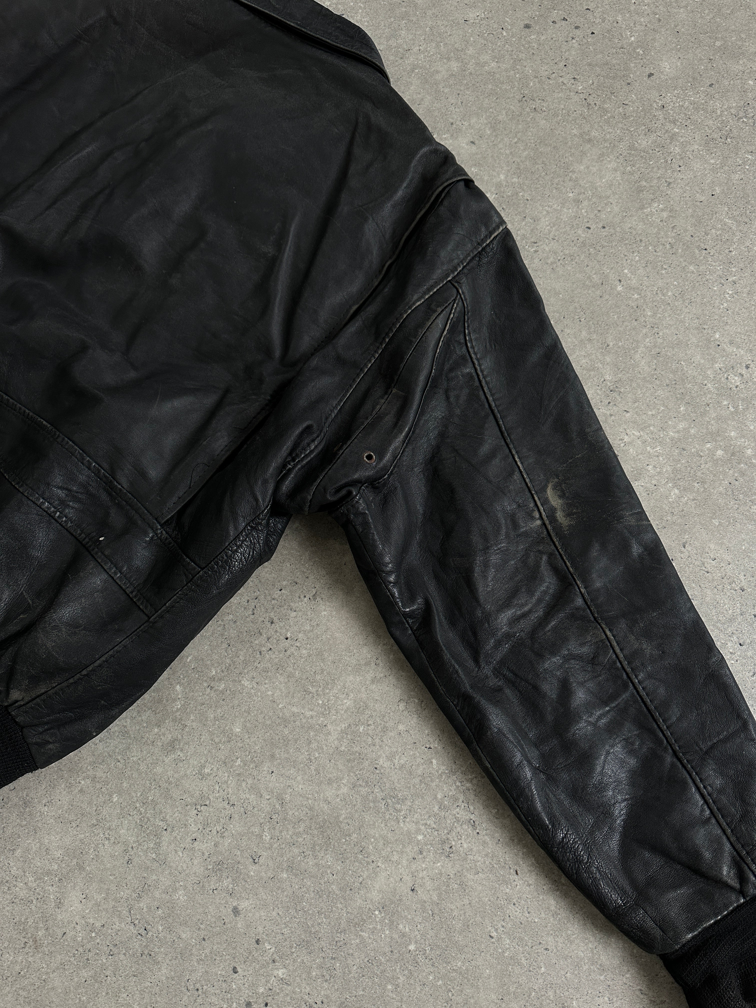 Vintage distressed leather bomber jacket in XL size, featuring a rugged style with visible wear and classic design elements.