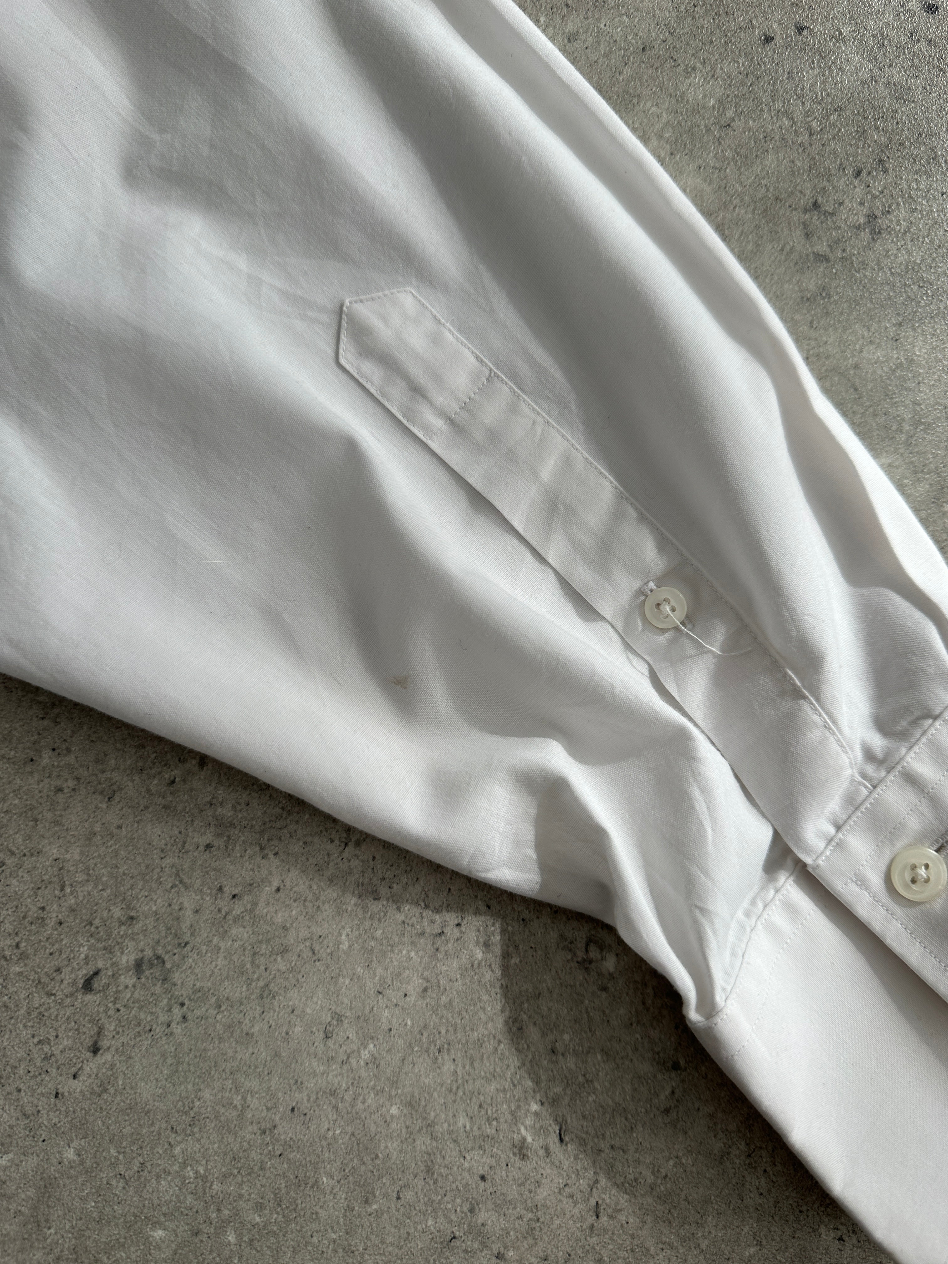 Yves Saint Laurent 90s cotton logo shirt in XL, featuring the iconic YSL logo and classic 90s style, displayed on a hanger.