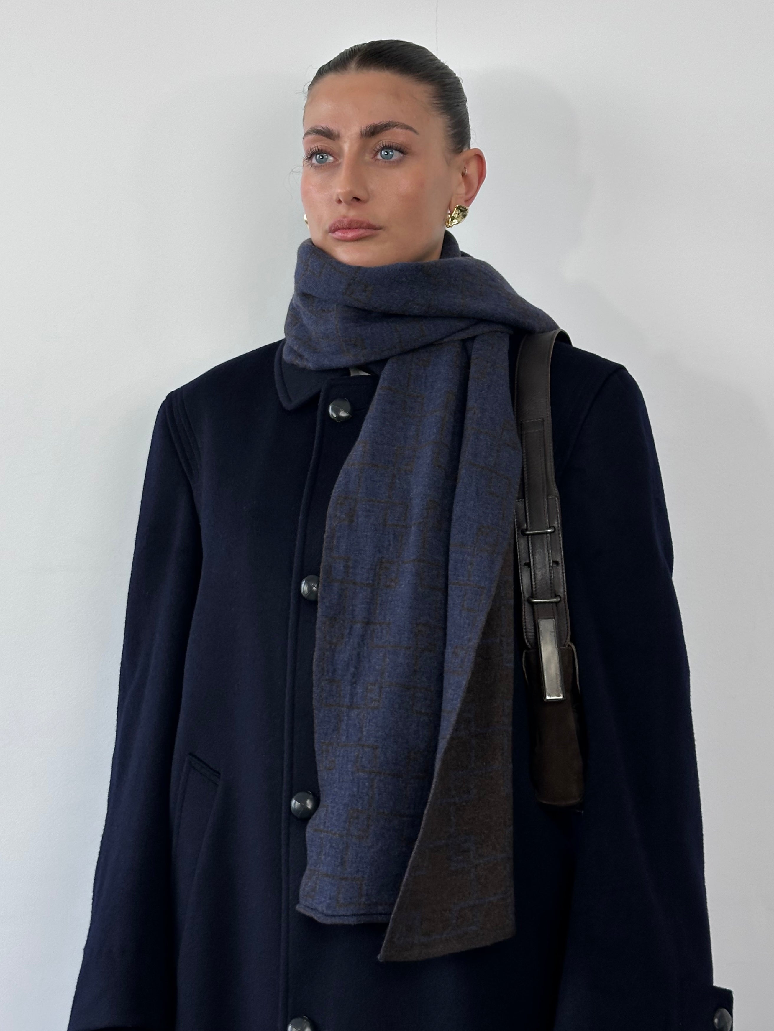 Fendi wool check scarf with classic plaid pattern in neutral tones, displayed draped on a neutral background.
