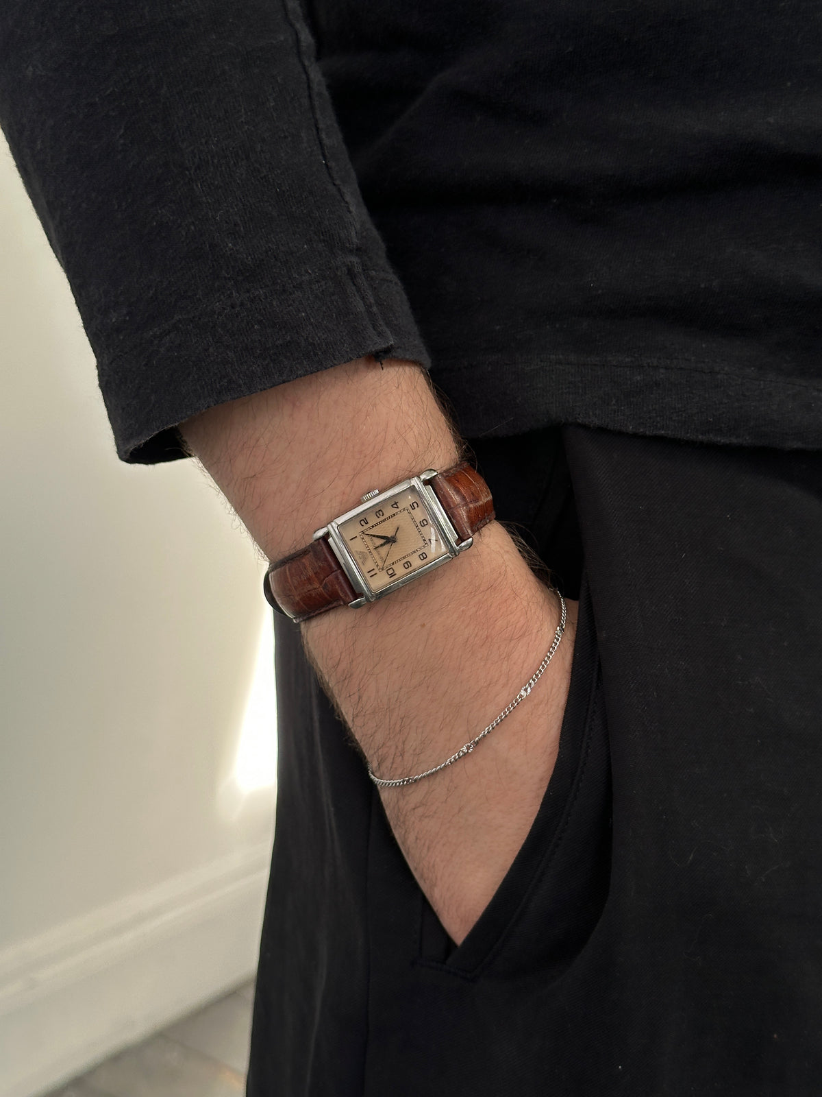 Emporio Armani 2000s leather rectangular quartz watch with silver dial and brown leather strap, close-up of the timepiece.