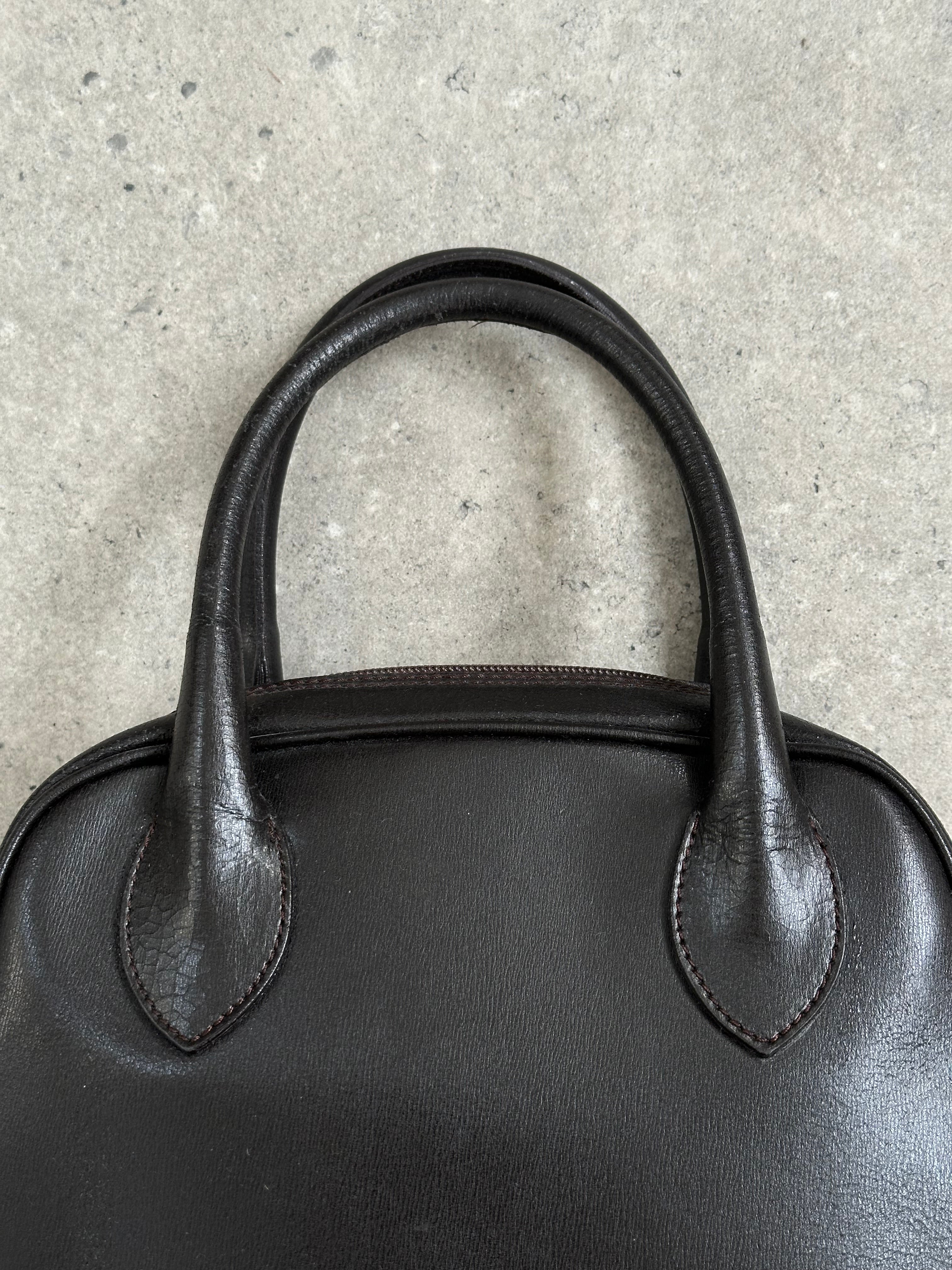 Emporio Armani leather handbag from the 2000s with sleek design and classic detailing, shown in a close-up view.