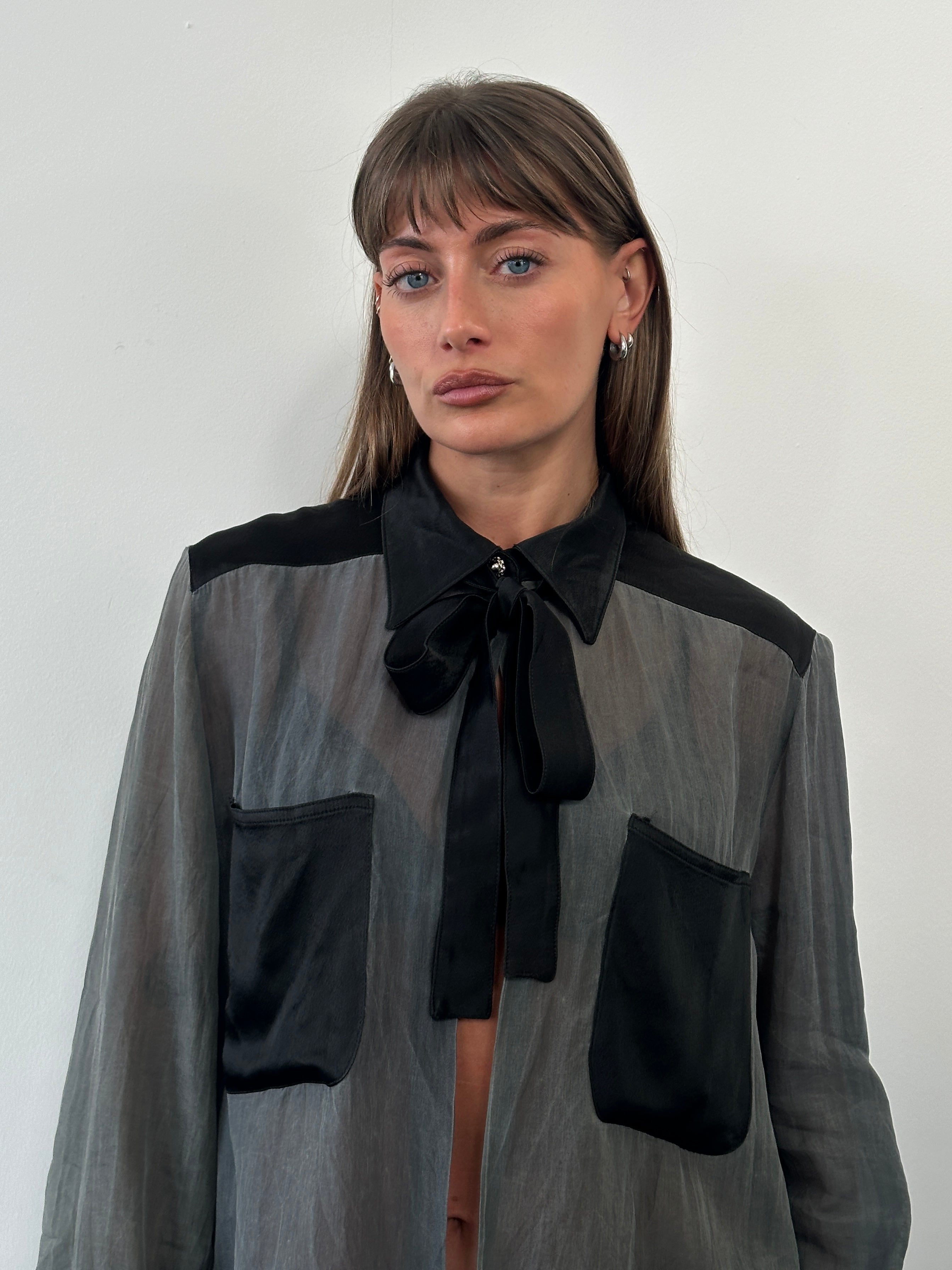 Vintage 1990s sheer satin tie-neck shirt in size M, featuring a classic button-up design with long sleeves.