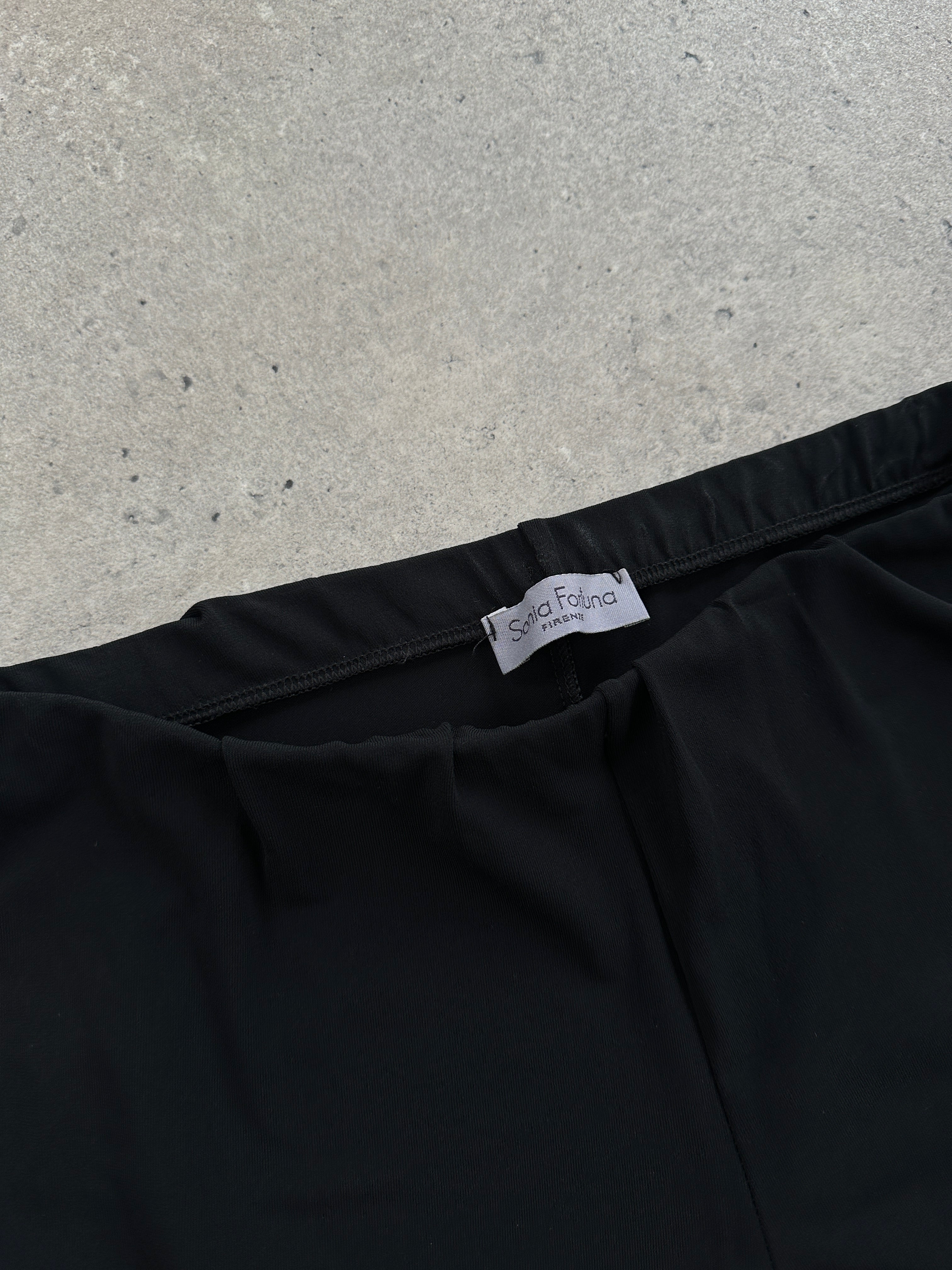 Vintage Italian vintage flared legging trousers with a high waist and retro style, showing the textured fabric and flared design.