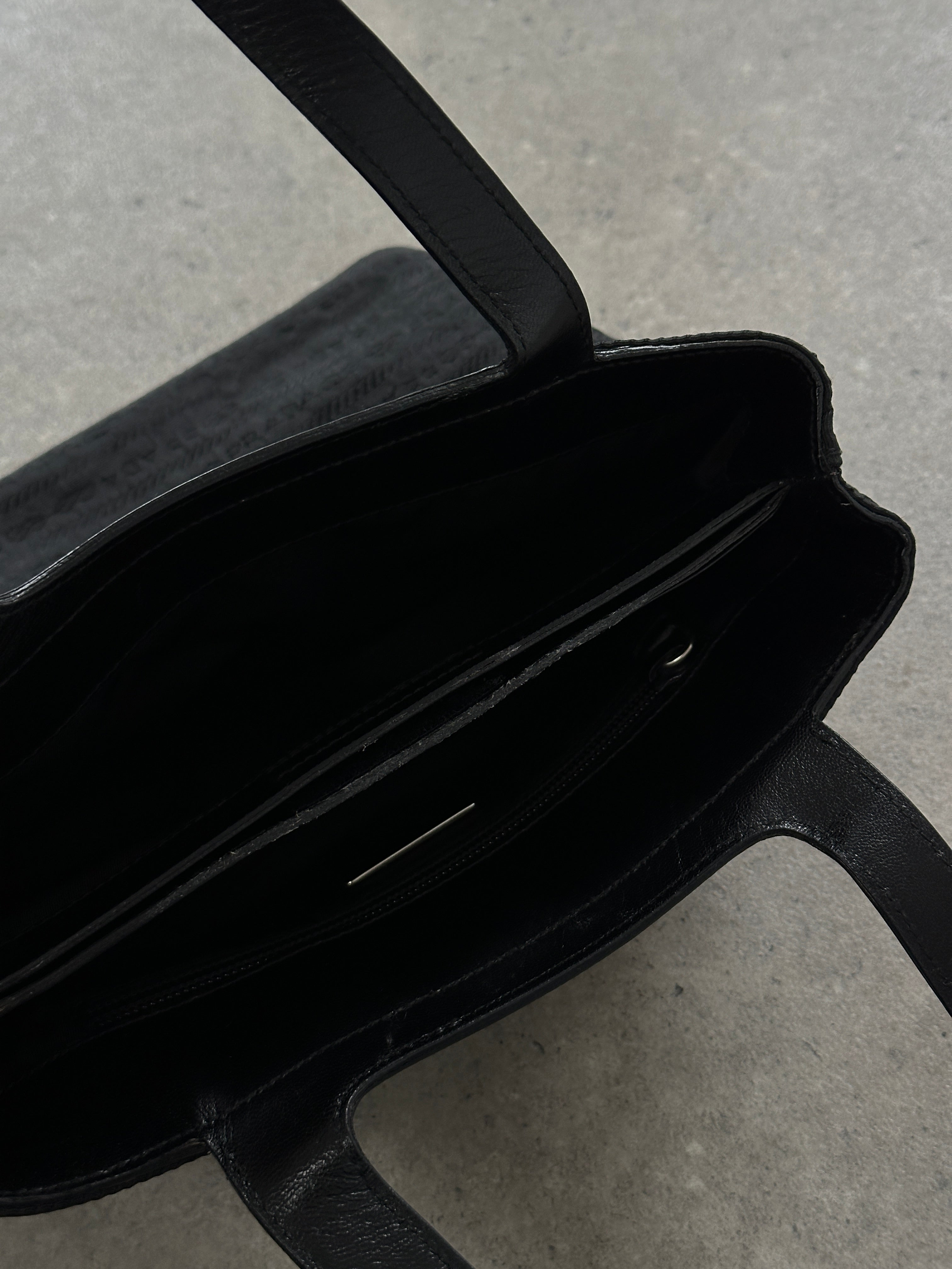 Prada 1990s Tessuto Monogram handbag with leather accents, featuring signature Prada monogram fabric and structured design.