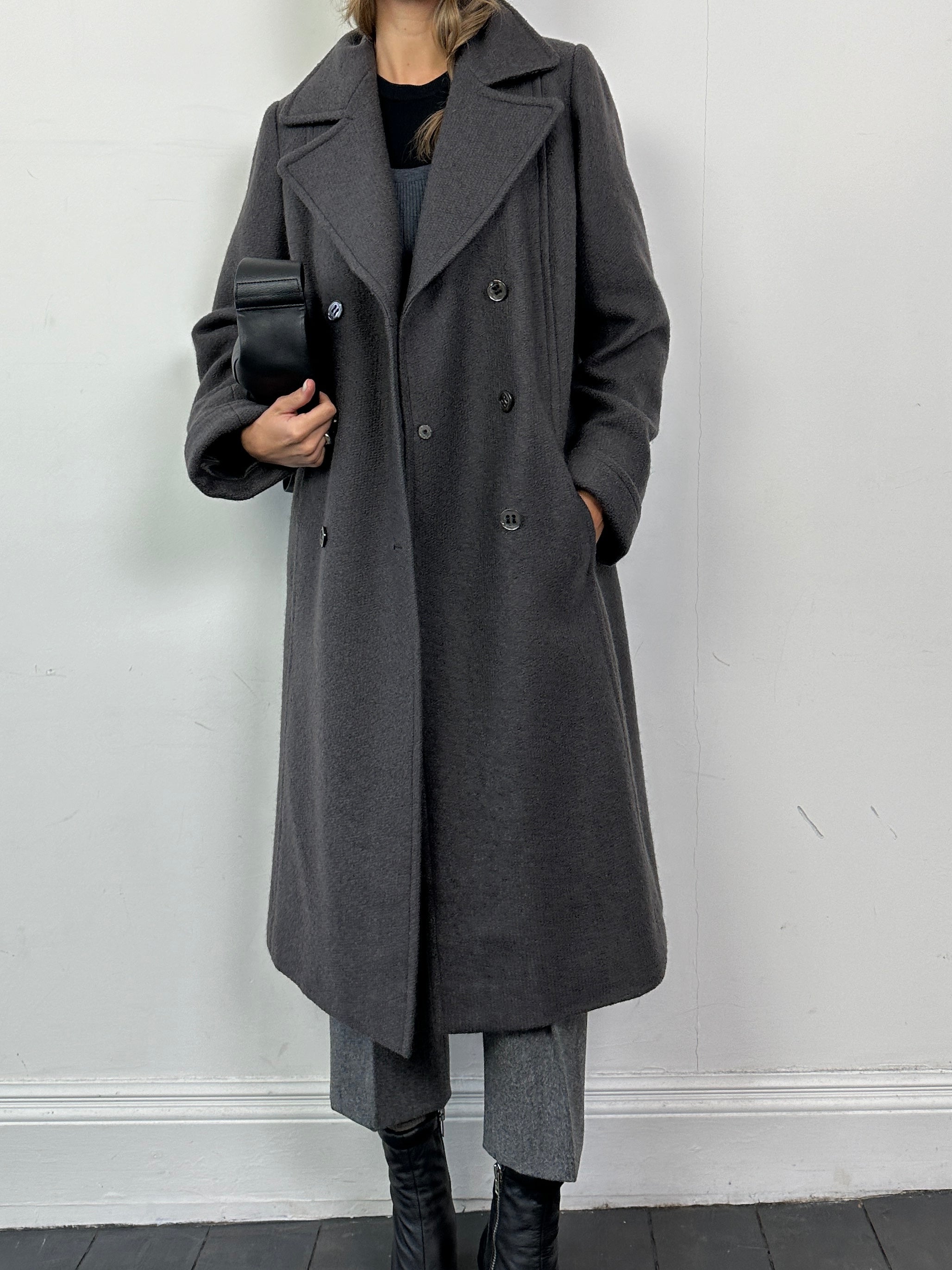 Vintage wool double-breasted A-line coat in M/L size, featuring classic design and tailored details, displayed on a hanger.