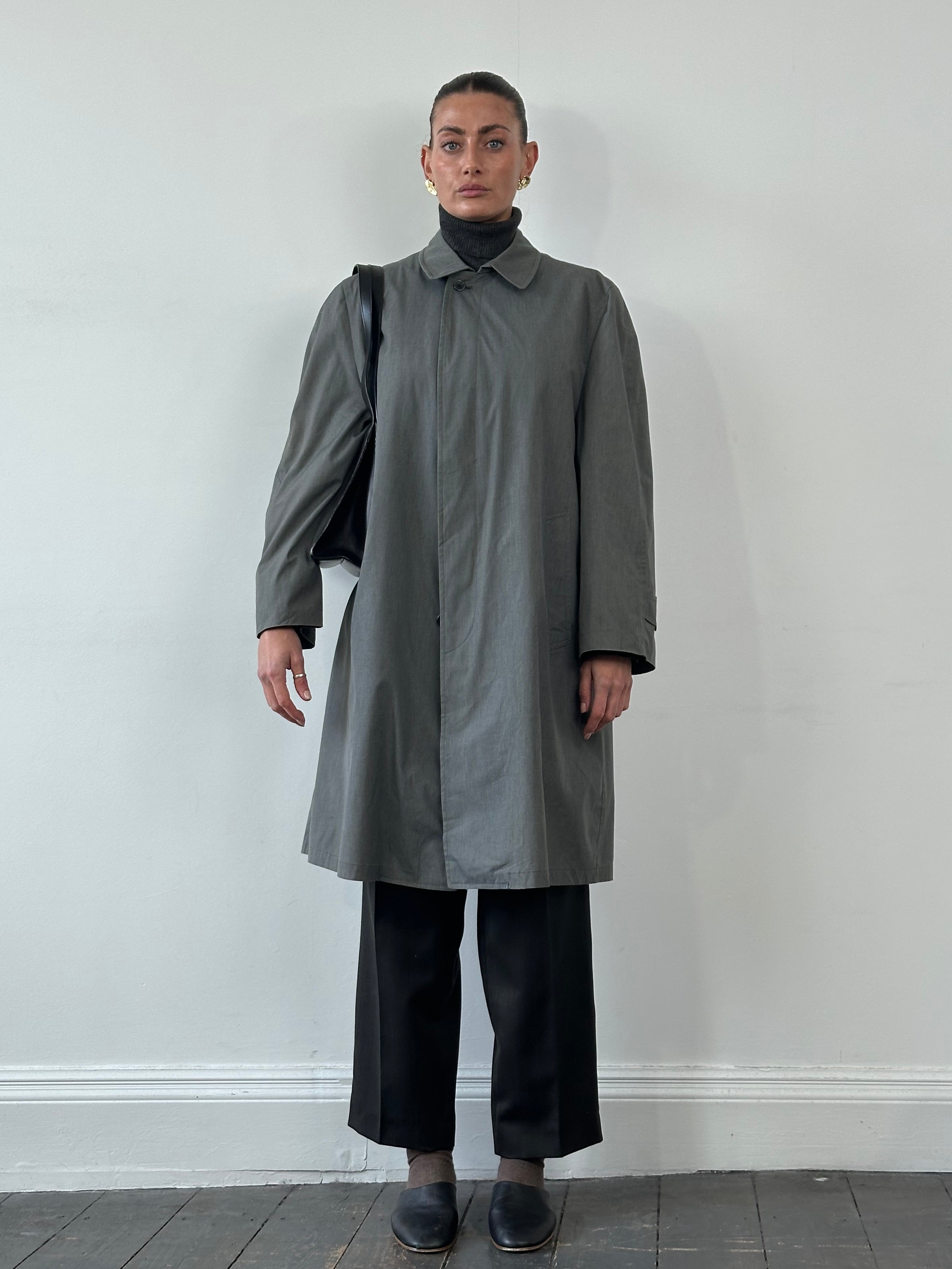 London Fog XL trench coat with concealed placket, stylish and water-resistant, shown hanging on a wooden hanger.