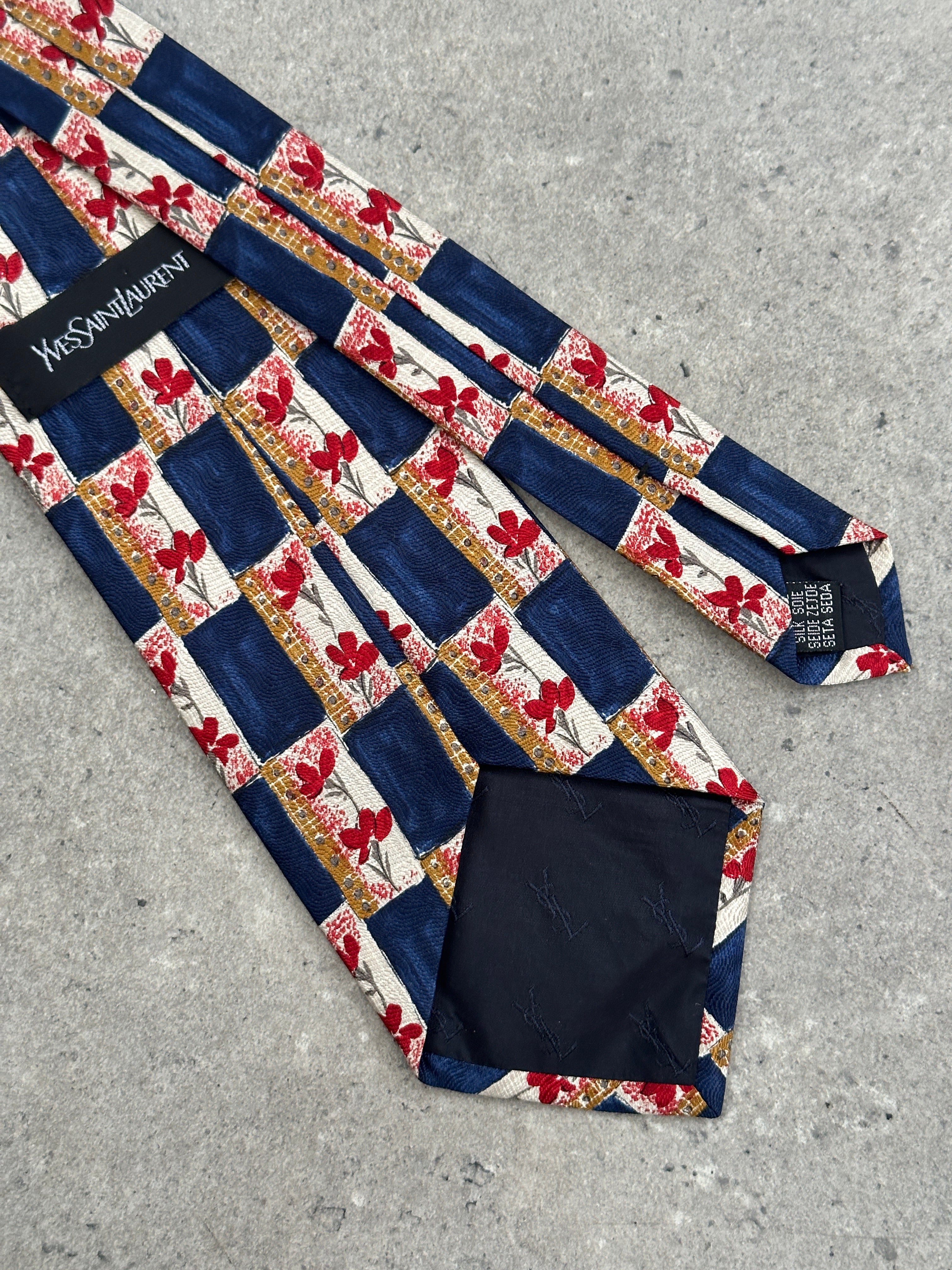Yves Saint Laurent 1990s silk tie featuring the brand's logo, with a smooth, shiny silk texture and classic tie design.