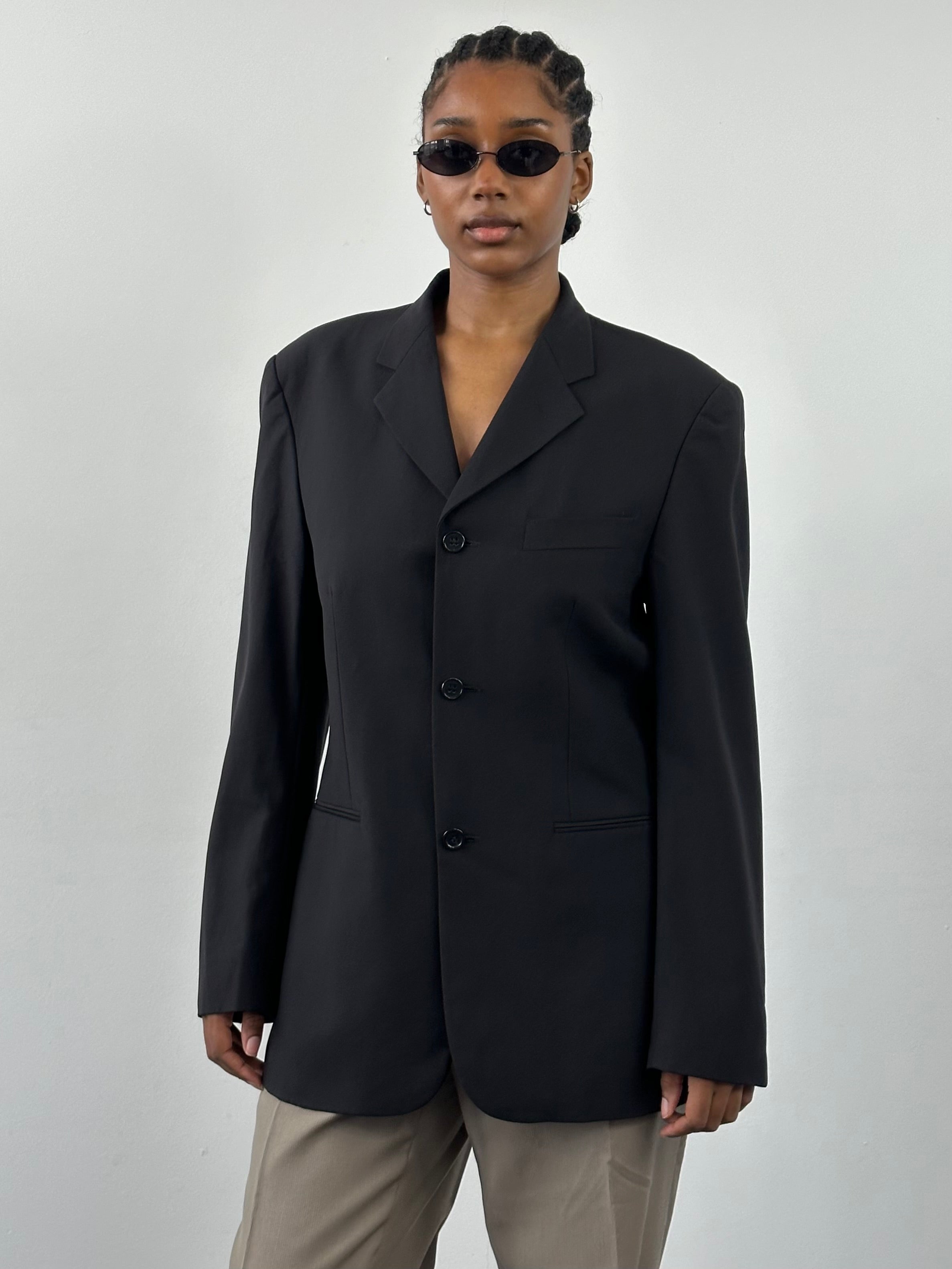 Yves Saint Laurent Pour Homme 1990s pure wool blazer in size 40R/L, tailored fit, classic dark color, shown on a hanger.